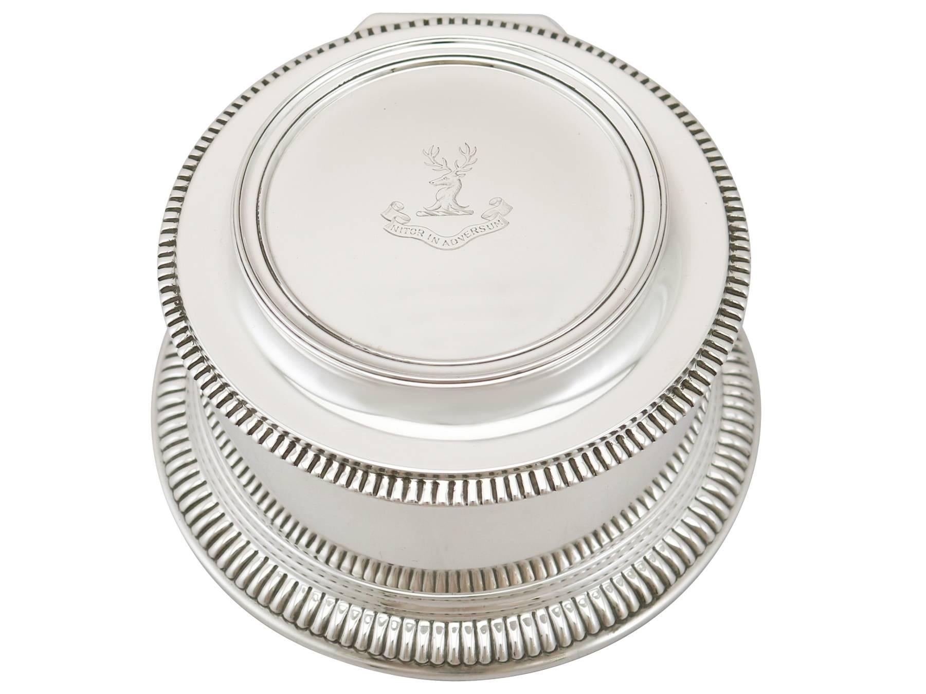 An exceptional, fine and impressive antique George V English sterling silver box made by Mappin & Webb Ltd; an addition to our ornamental silverware collection.

This exceptional antique George V sterling silver box has a circular swept form, in