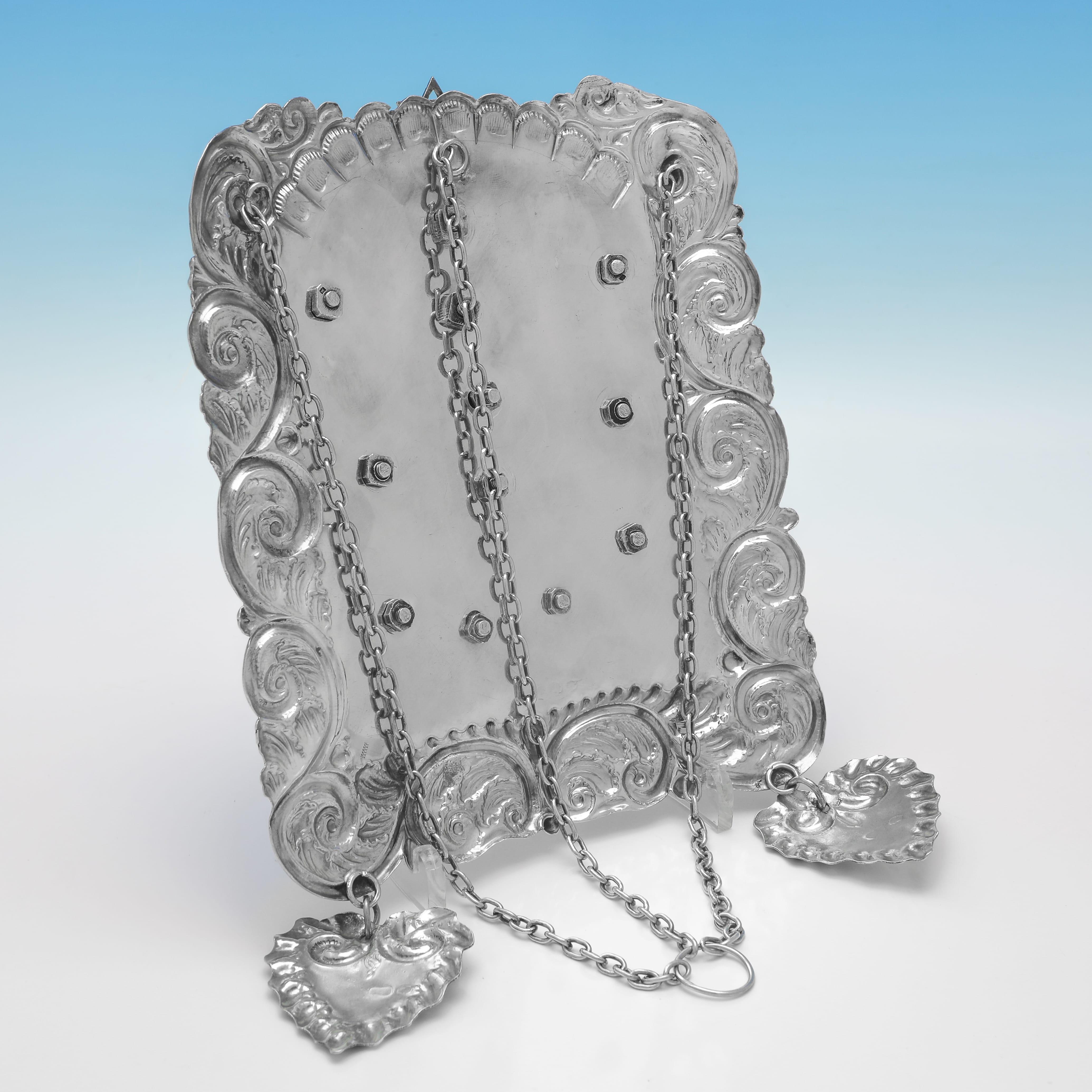 Hallmarked in London in 1922 by Jacob Rosenzweig, this Antique Sterling Silver Breastplate, is of traditional form, decorated with two Lions of Judah holding a depiction of the Crown of the Law, the tablets with the engraved Ten Commandments in