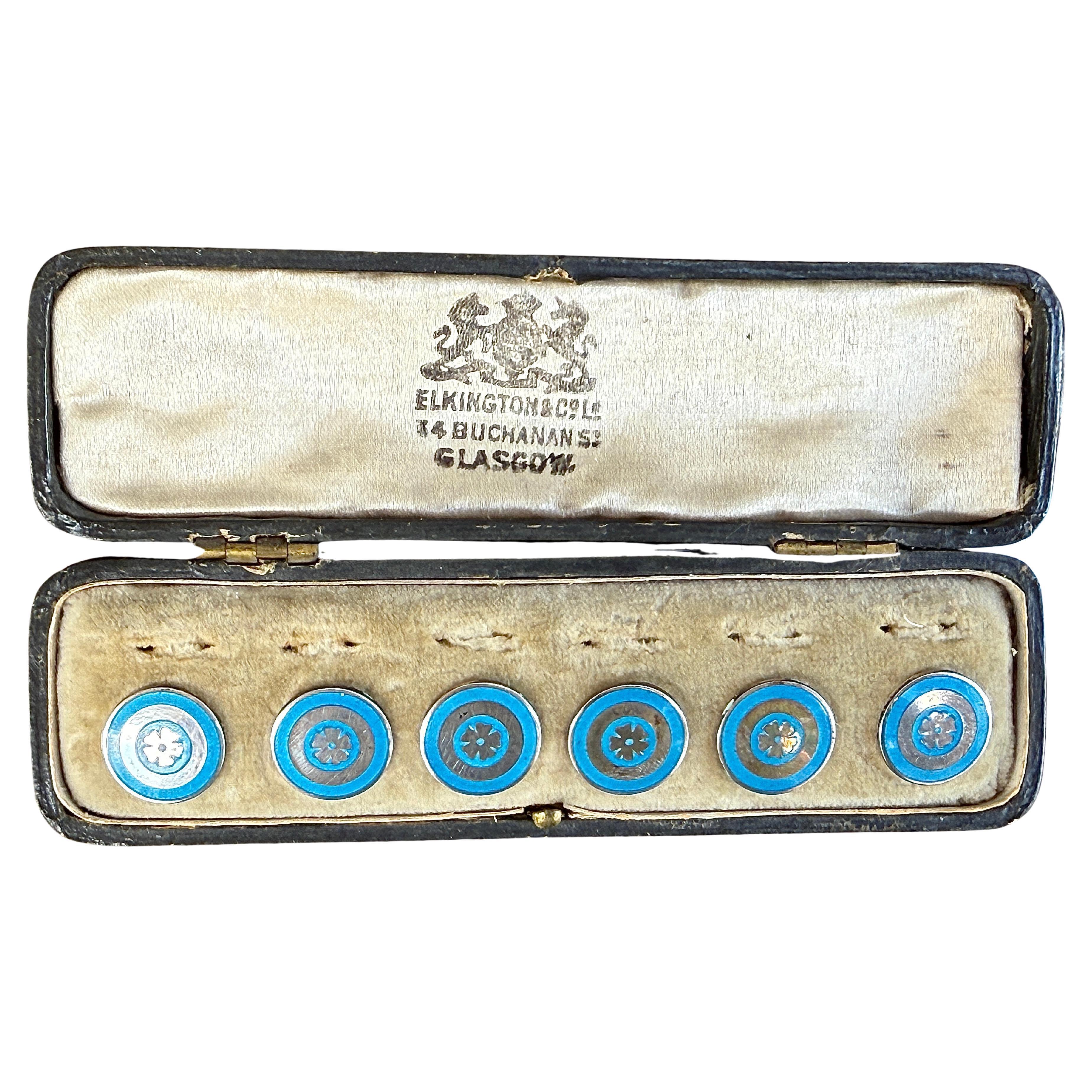 This set of six sterling silver buttons are decorated with a Tudor rose on turquoise ground surrounded by a turquoise circle. Each button is impressed with the left facing lion for sterling silver, the anchor mark for Birmingham as the place of