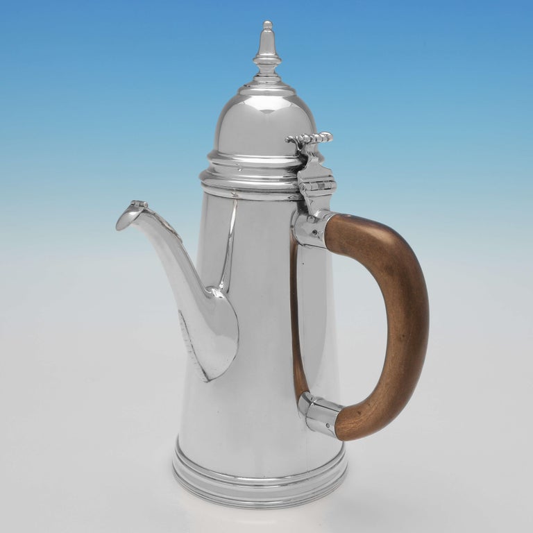Hallmarked in London, 1913 by William Comyns, this handsome, antique sterling silver cafe Au Lait, are plain in style, and feature loop wooden side handles, reed borders, and bead detailing to the spout of the coffee pot. 

Each measures
