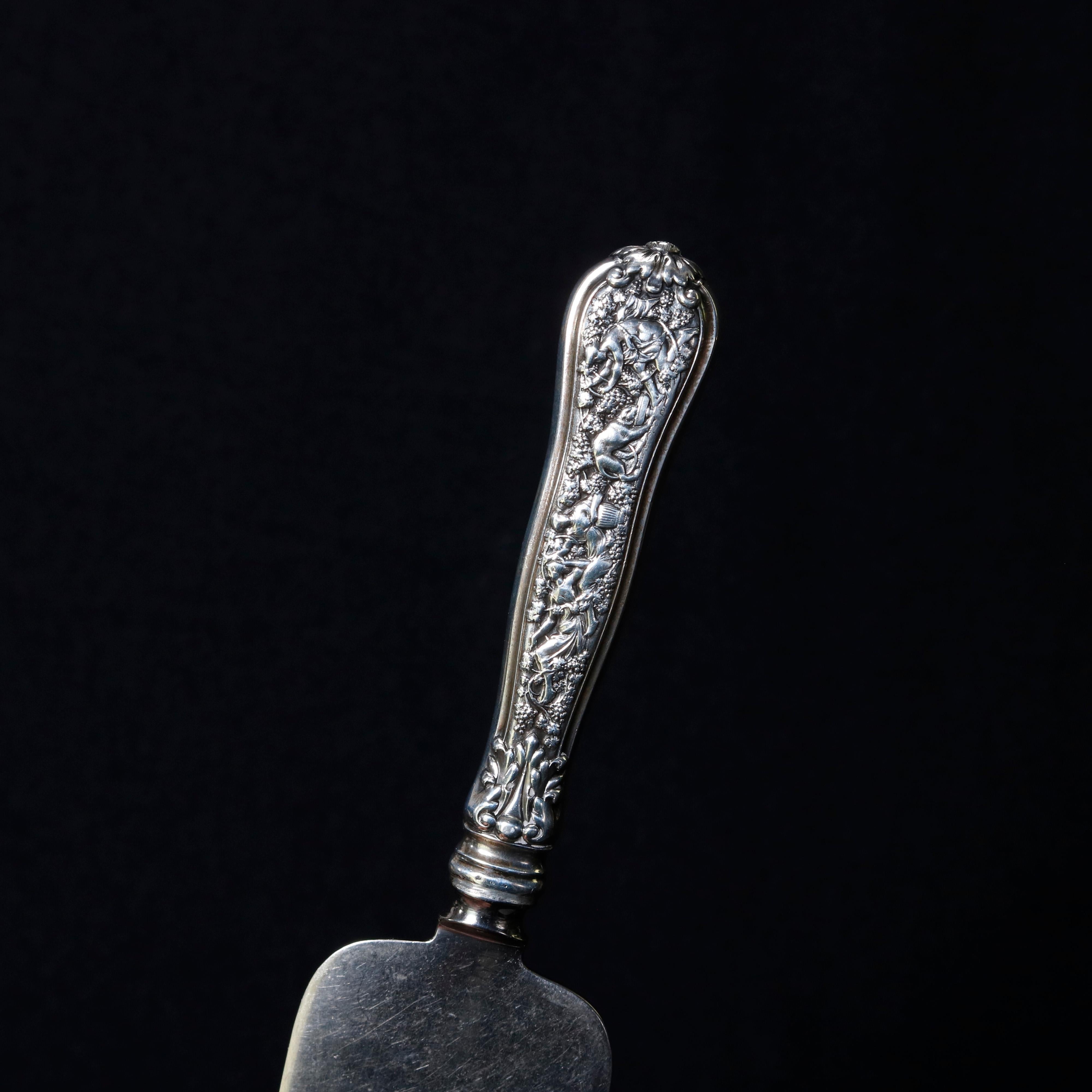 An antique sterling silver cake server by Tiffany & Co. in the Olympian pattern depicts high relief classical scene with figures, circa 1870

***DELIVERY NOTICE – Due to COVID-19 we are employing NO-CONTACT PRACTICES in the transfer of purchased