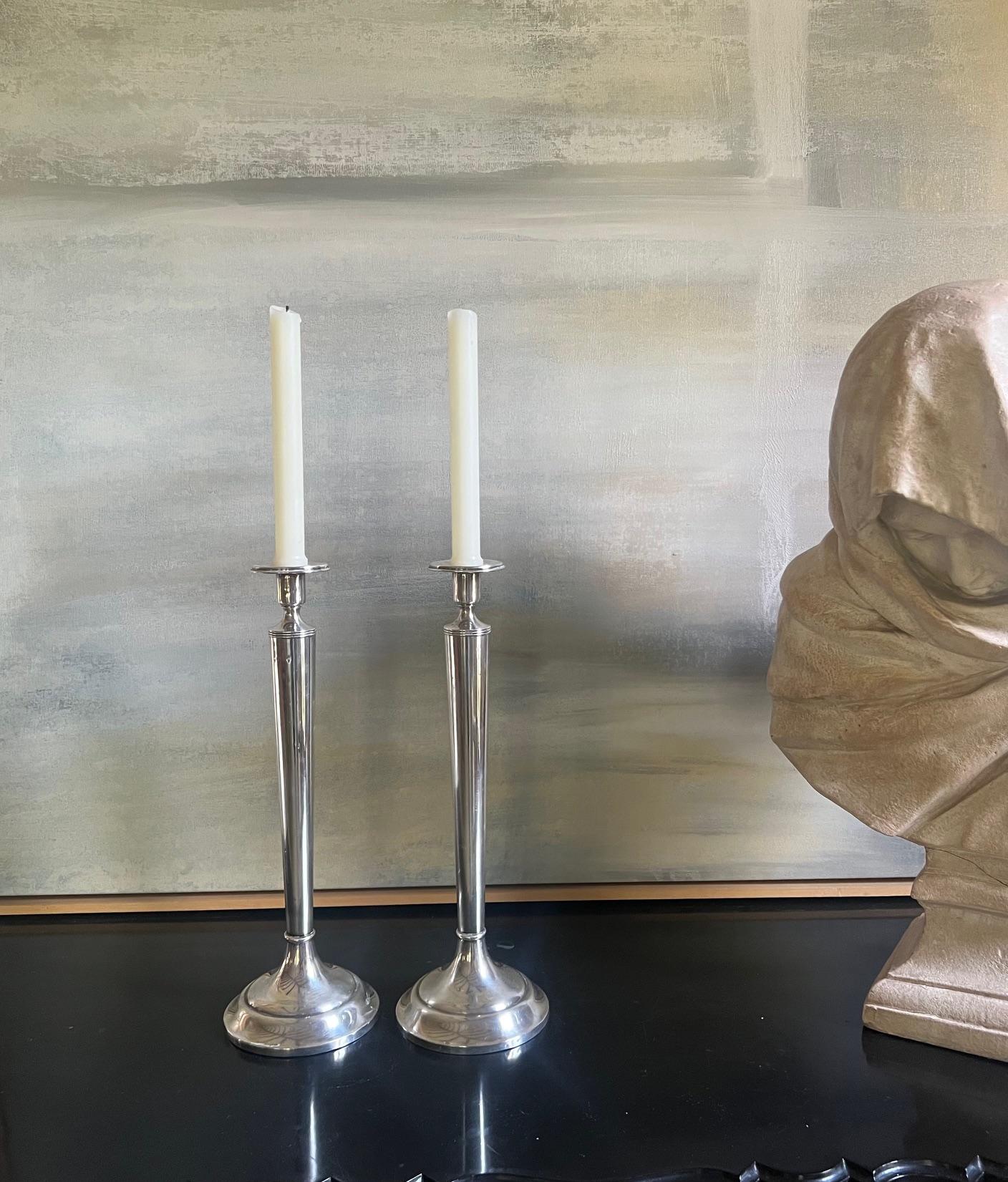 Stately and tall set of two antique sterling silver candle sticks.  The maker is unidentified, each candlestick is market Sterling 71