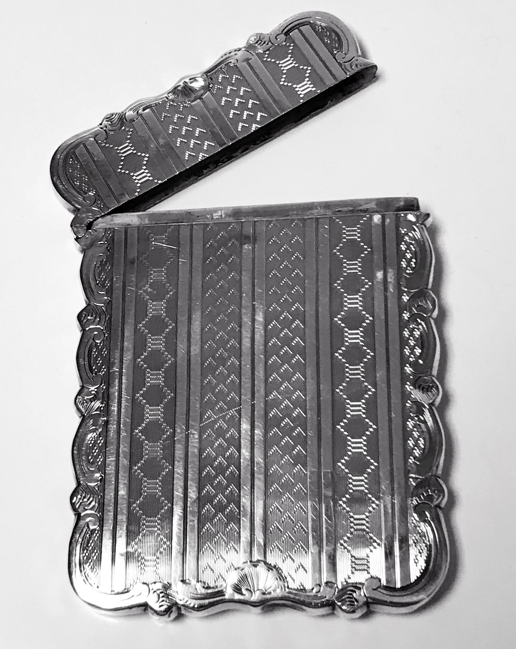 Antique Sterling Silver Card Case, Birmingham 1866 Hilliard and Thomason. The card case rectangular form engraved panels design centering engraved cartouche with scroll foliage edging, hinged cover. Measures: 9.50 x 7.00 cm. Total item weight: 54.89