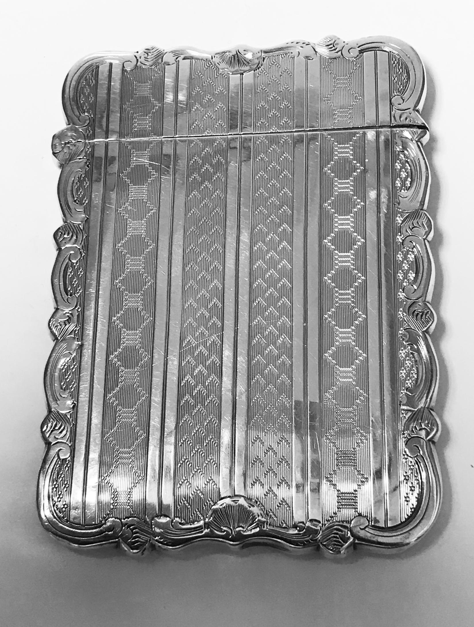 Antique sterling silver card case, Birmingham 1866 Hilliard and Thomason. The card case rectangular form engraved panels design centering engraved cartouche with scroll foliage edging, hinged cover. Measures: 9.50 x 7.00 cm. Total item weight: 54.89
