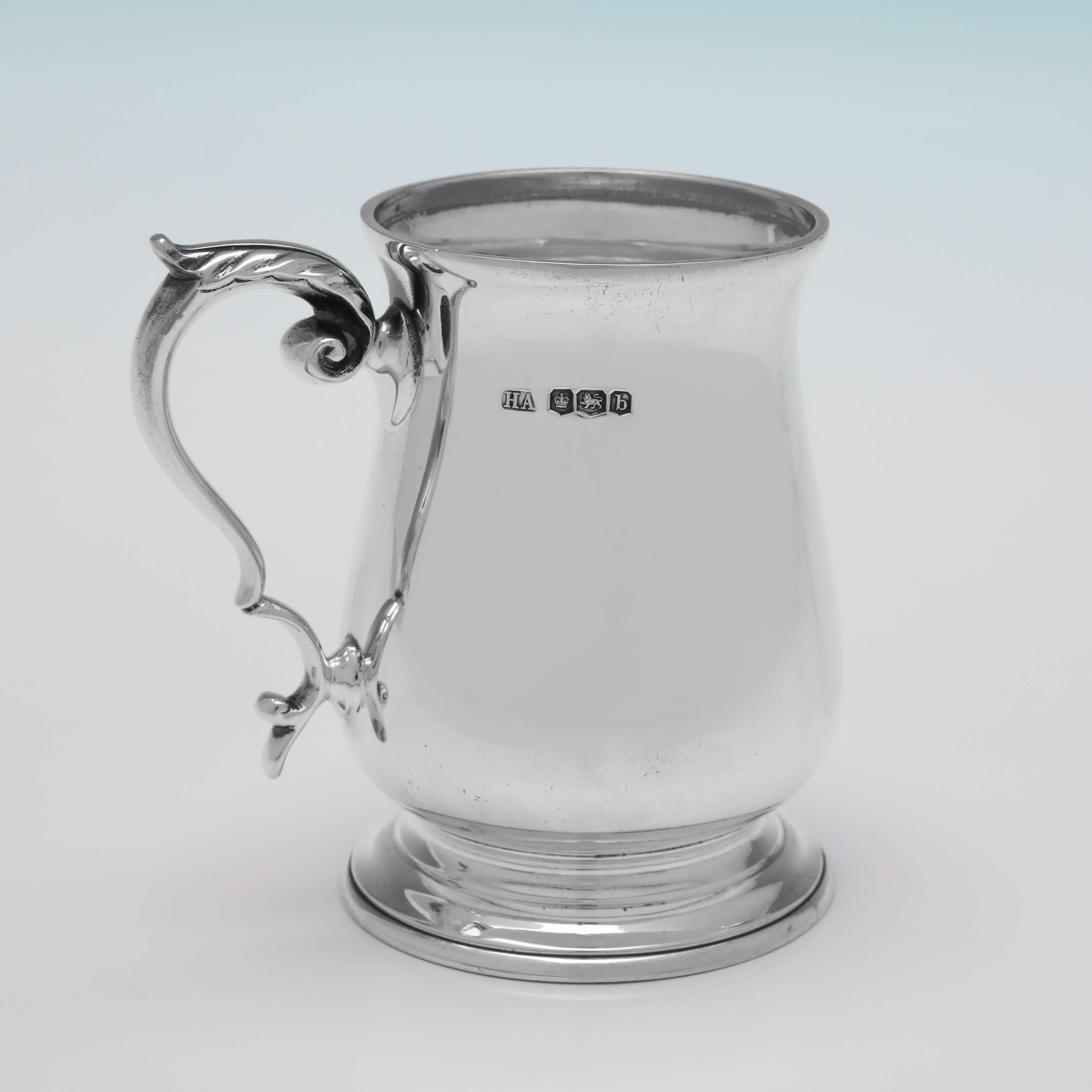 Hallmarked in Sheffield in 1919 by Atkin Brothers, this handsome, Antique sterling silver Christening mug, is in the traditional baluster shape. The christening mug measures 3.5