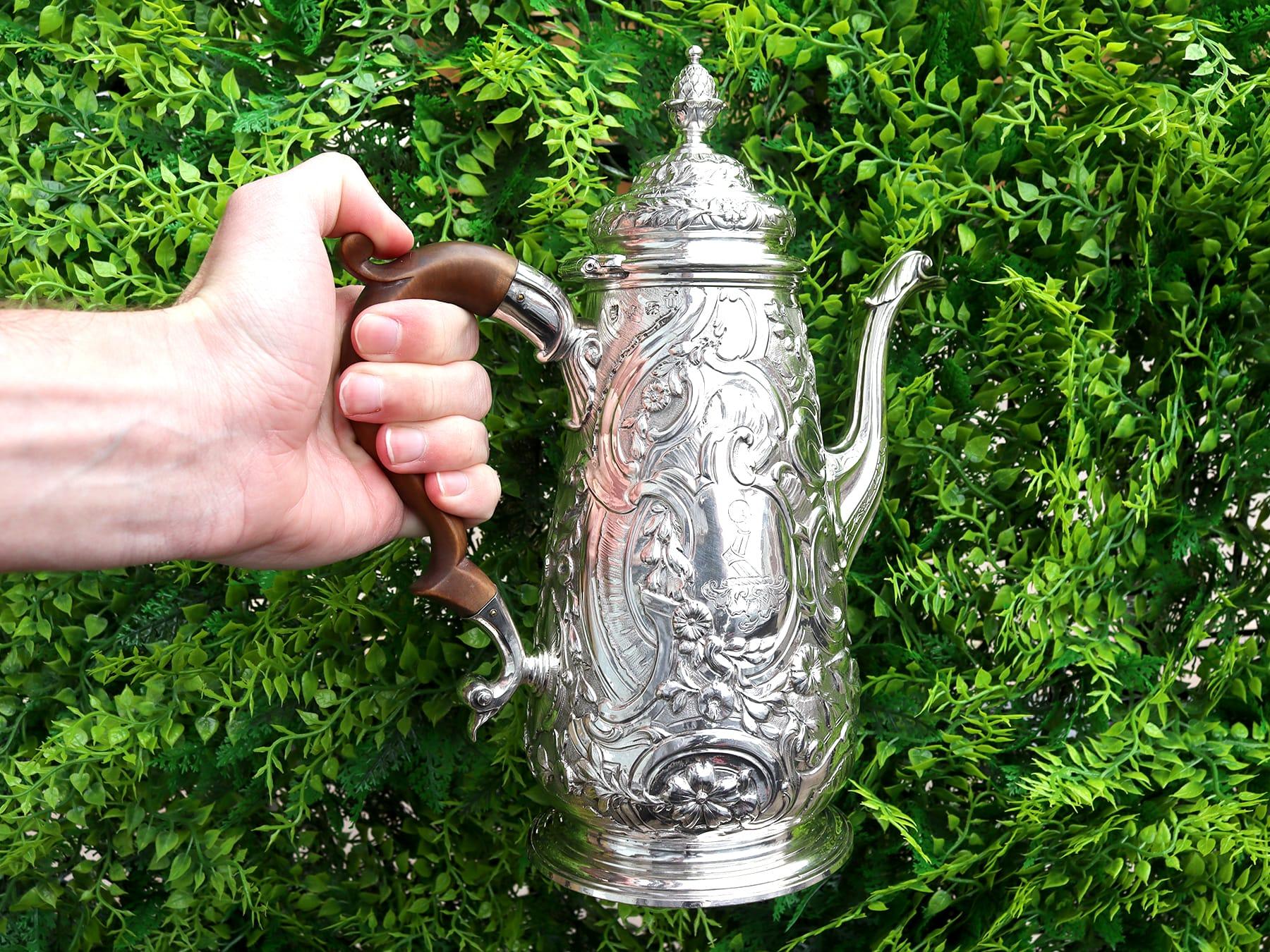 An exceptional, fine and impressive antique George II English sterling silver coffee pot; an addition to our Georgian silver teaware collection.

This exceptional antique George II sterling silver coffee pot has a tapering circular rounded form