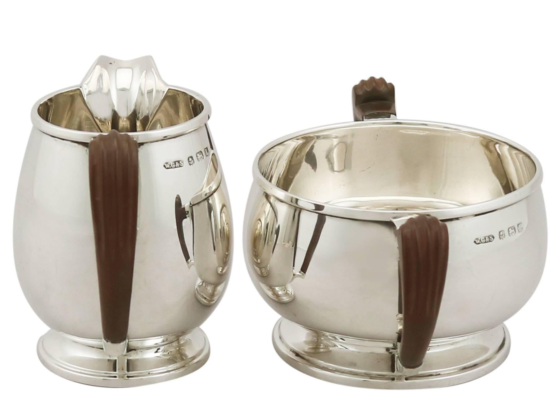 A fine and impressive antique George V English sterling silver cream jug and sugar bowl set in the Art Deco style, an addition to our silver teaware collection.

This exceptional antique George V English sterling silver cream and sugar have a