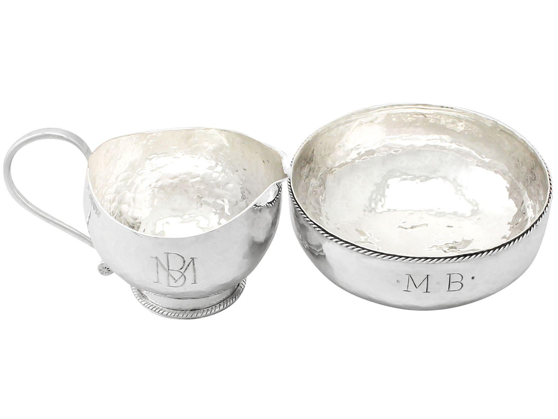 An exceptional, fine and impressive antique George V English sterling silver sugar bowl and creamer made by Hugh Wallis, in the Arts & Crafts style; an addition to our sterling teaware collection.

This exceptional antique George V sterling silver