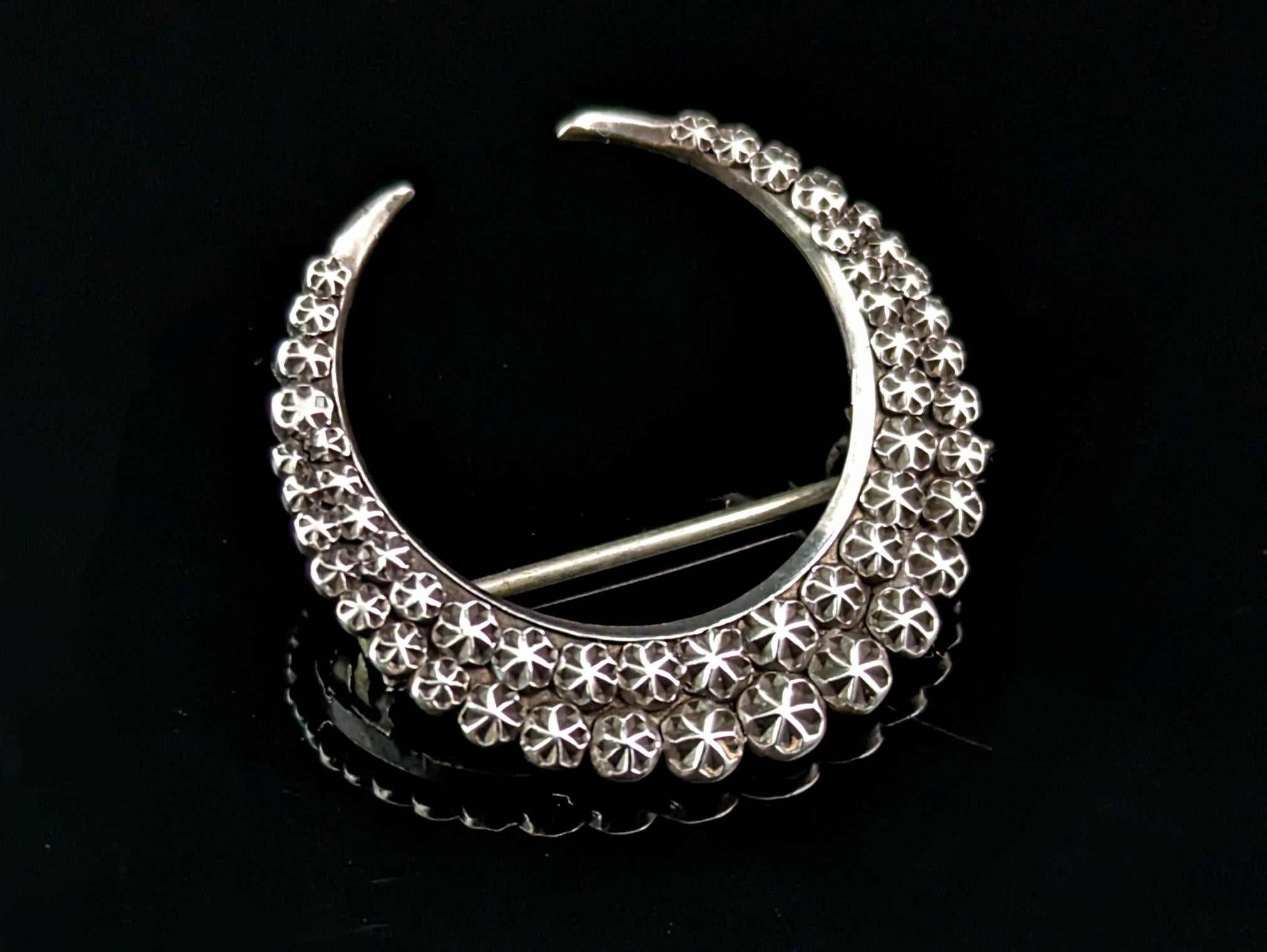 If you are a lover of celestial jewellery then this one is for you! A sterling silver crescent moon brooch by Charles Horner.

A beautiful curved moon with a pastry cutter texture with an almost star like pattern by a renowned maker of the era and