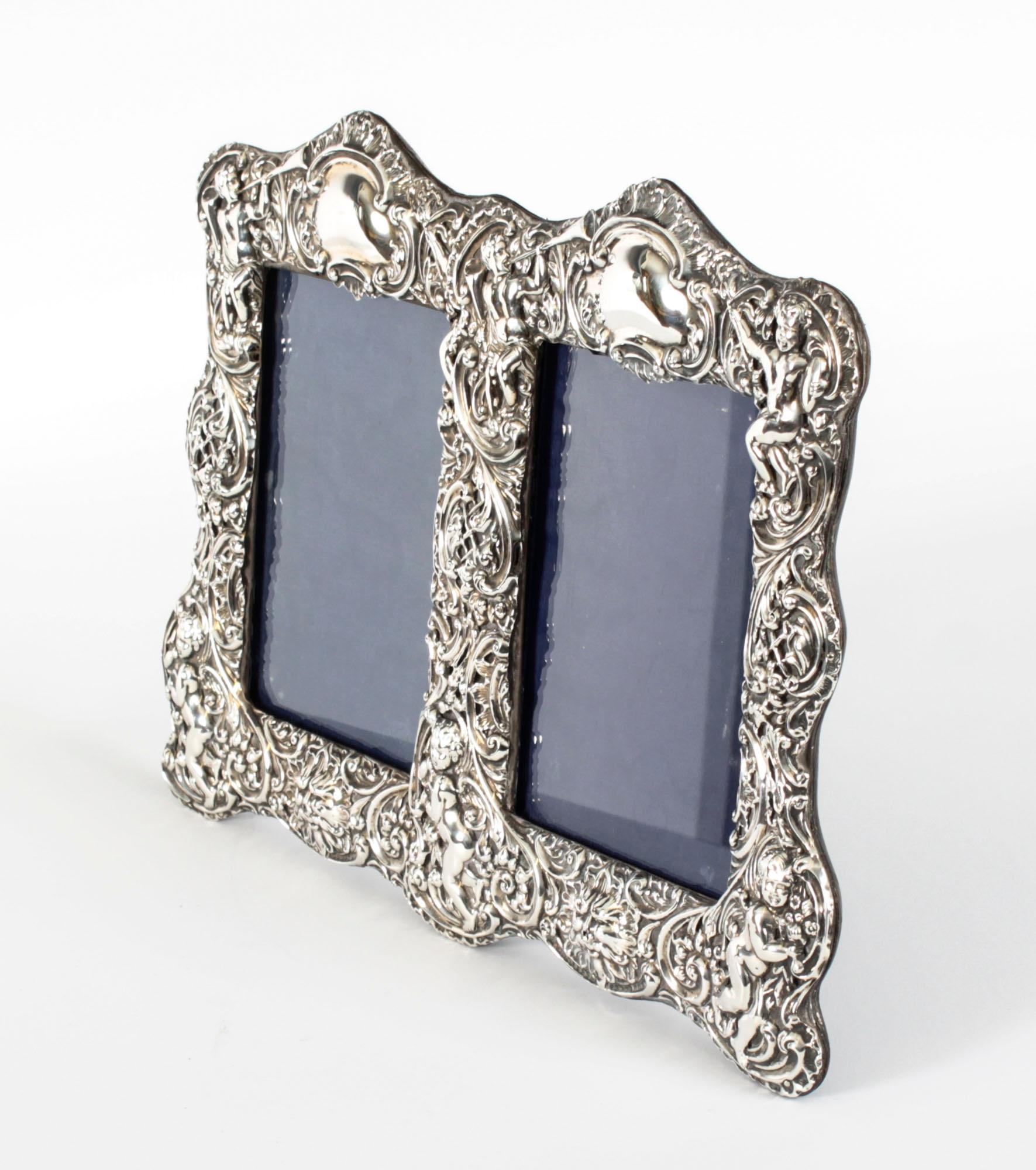 A truly superb antique Edwardian sterling silver photo frame by Synyer & Beddoes (Harry Synyer & Charles Joseph Beddoes) with  hall marks for Birmingham and dated 1901.

The beautiful double portrait frame is decorated with relief Rococo revival
