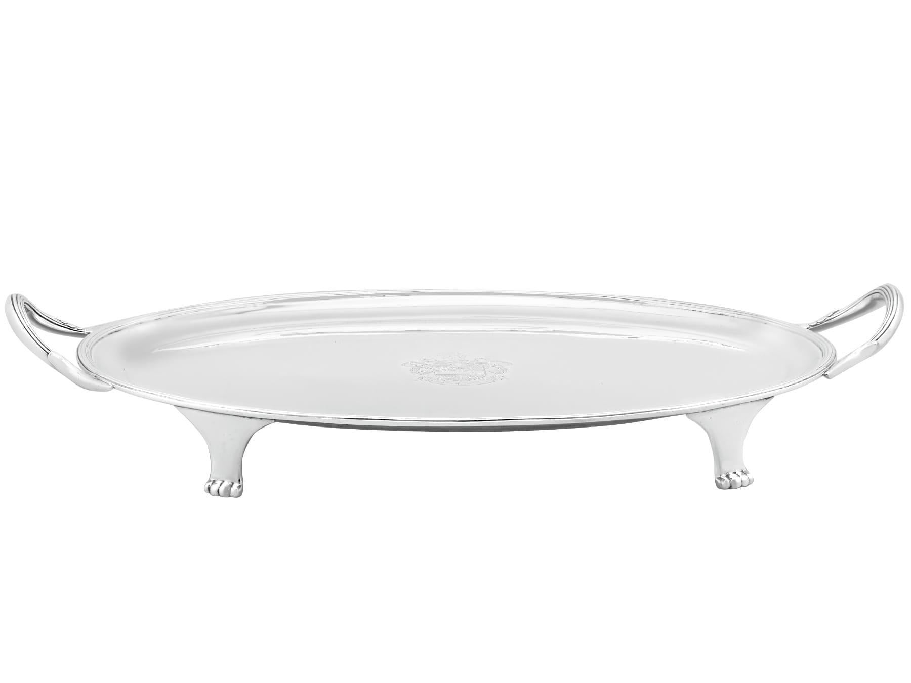 An exceptional, fine and impressive antique George V English sterling silver two handled drinks tray; an addition to our silver tray collection.

This exceptional antique George V sterling silver tray has an oval form.

The surface of this