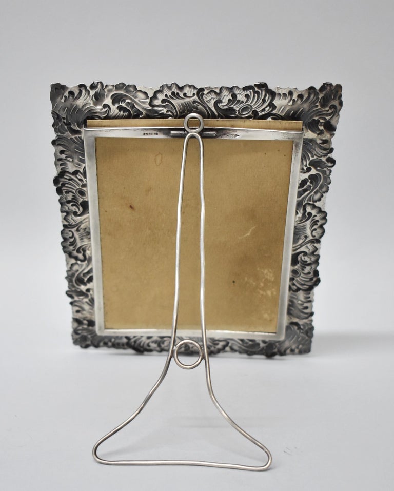 Beautiful ornate sterling silver easel back picture frame by George W. Schiebler & Co. Outside dimensions of 6 1/4