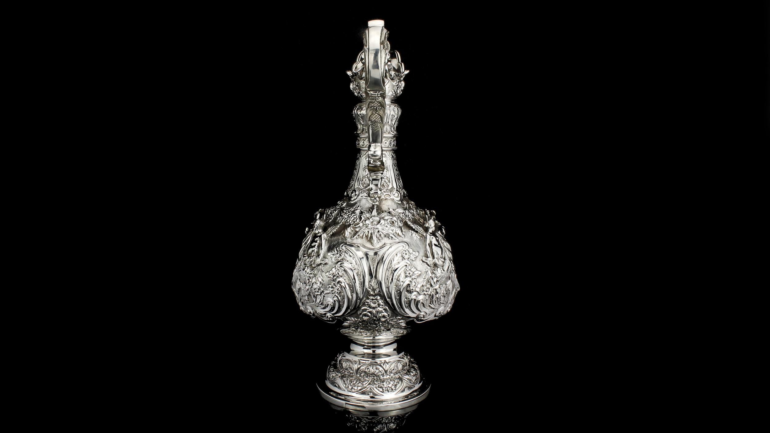 Antique sterling silver elaborately engraved armada jug
Maker: Martin Hall & Co
Made in Sheffield 1905
Fully hallmark.

Has engraved Virtutis gloria merces (Glory is the reward of valour)

Dimensions - 
Height 36.5 cm
Width 18 cm
Weight