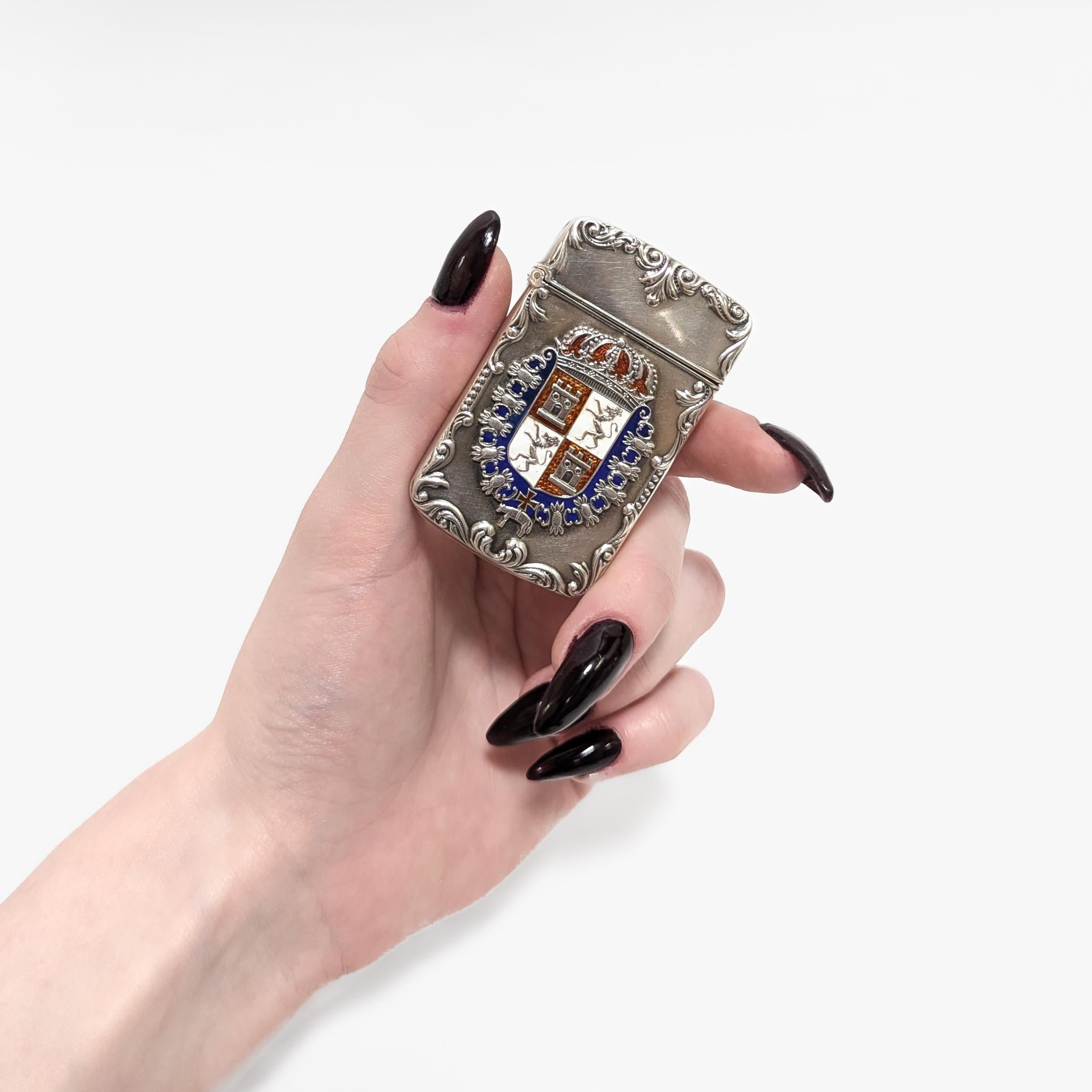 A fine antique silver & enamel matchsafe.

In sterling silver.

Decorated with the Spanish Coat of Arms to the front.

With repousse rocaille decoration around the edges.

Marked to the lip beneath the lid.

Simply a wonderful antique