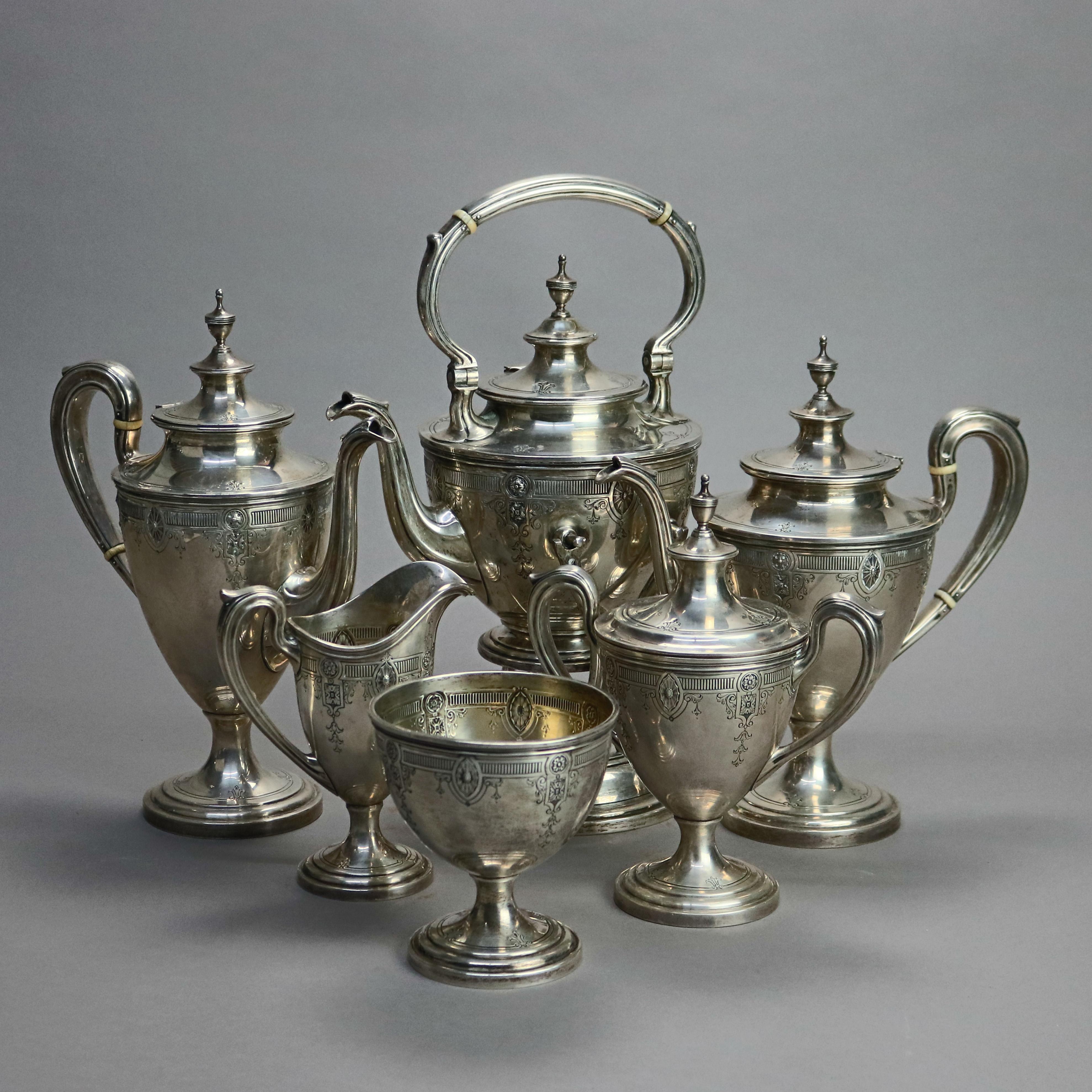An antique tea set by Dominick & Haff offers sterling silver construction with engraved foliate, patera and reed elements and includes six pieces as outlined below, maker mark as photographed, 134.1 toz, early 20th century

Measures: Water pot on
