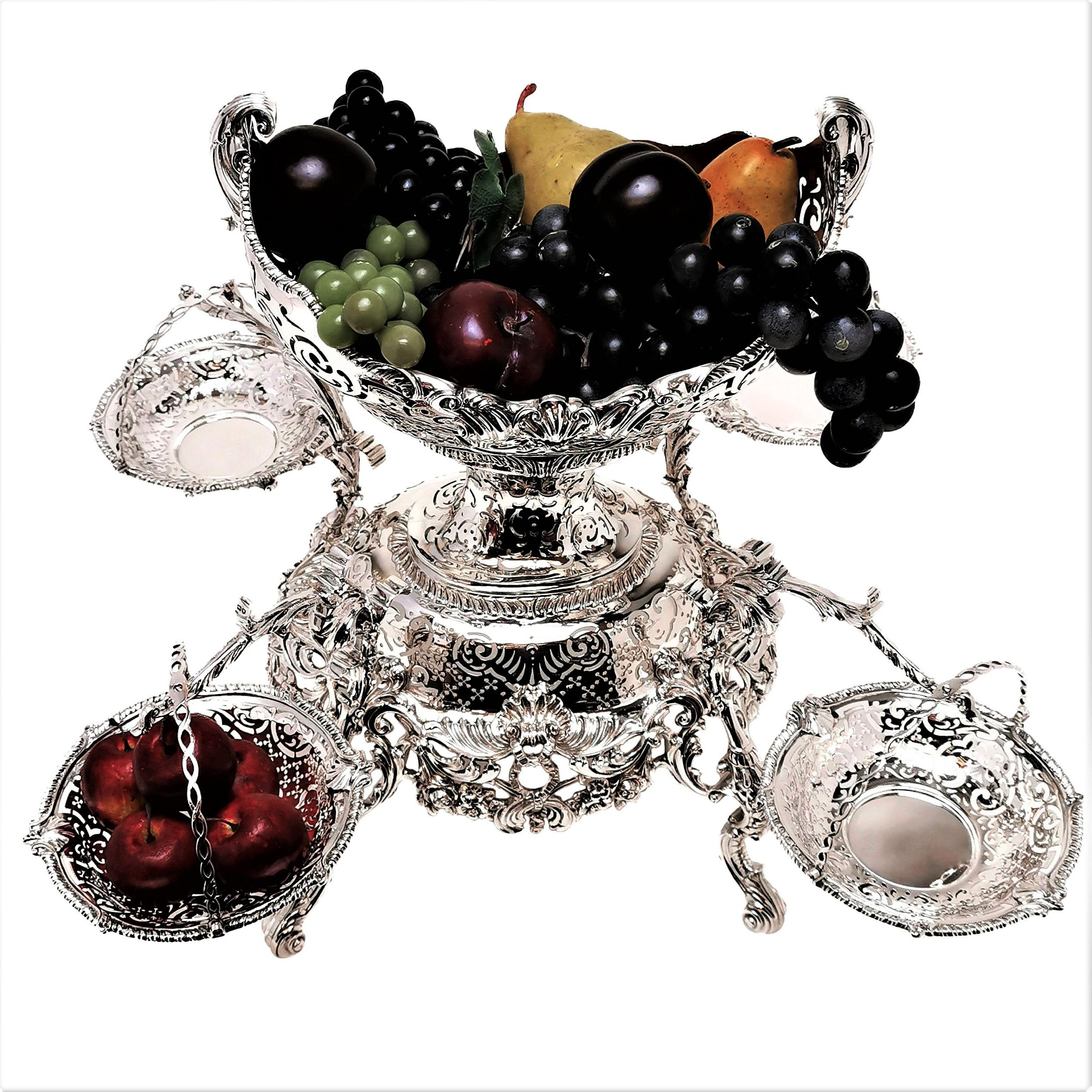 A magnificent Antique sterling Silver Epergne crafted to an excellent standard in the style of a George III c. 1765 style Centrepiece. This Silver Centrepiece features a large central basket and four smaller hanging baskets. The Silver Baskets can