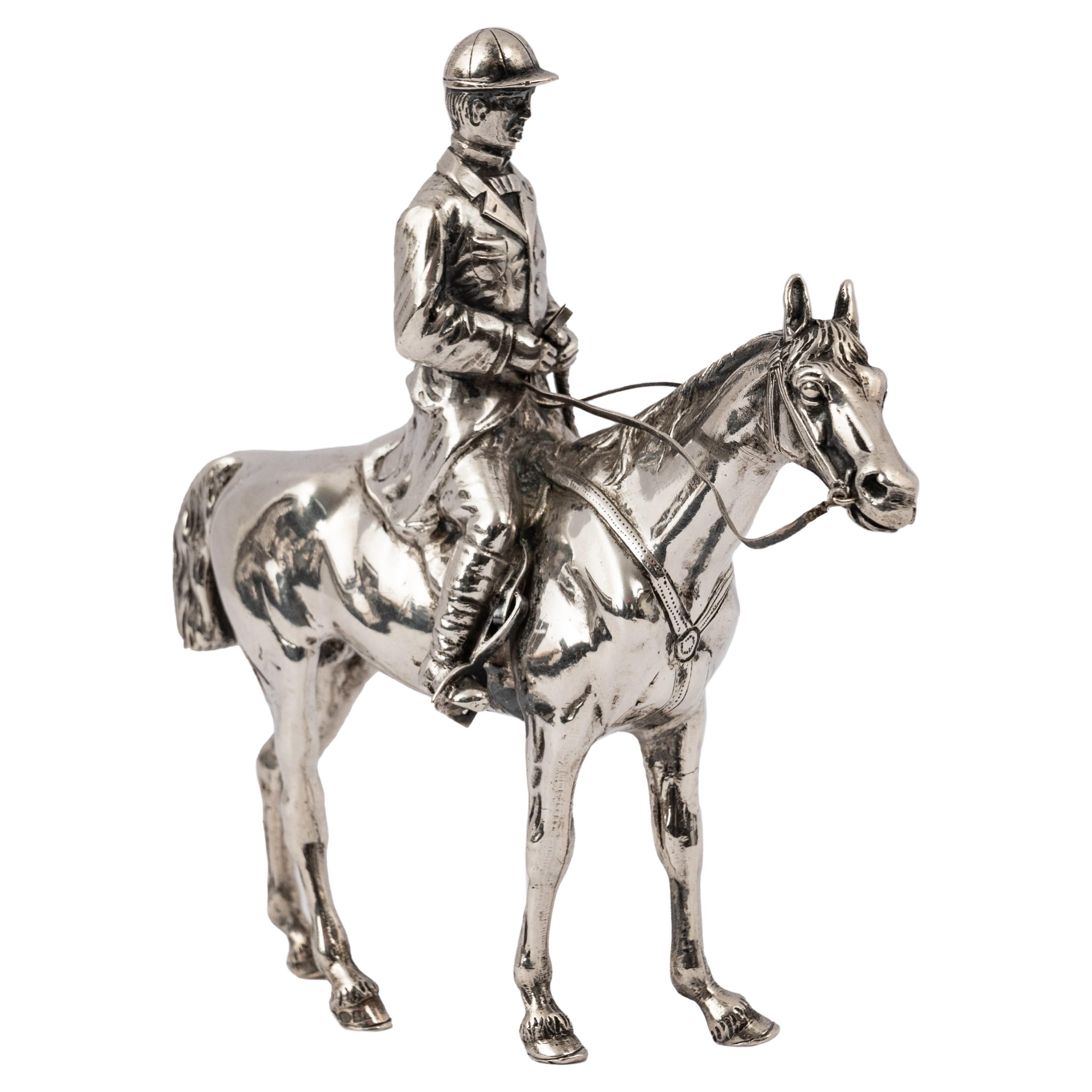 A good antique sterling silver equestrian horse & rider sculpture, circa 1920.
The statuette is very finely modeled as a rider and his horse and most likely engaged in dressage, the rider is dressed in traditional English riding attire. Both the