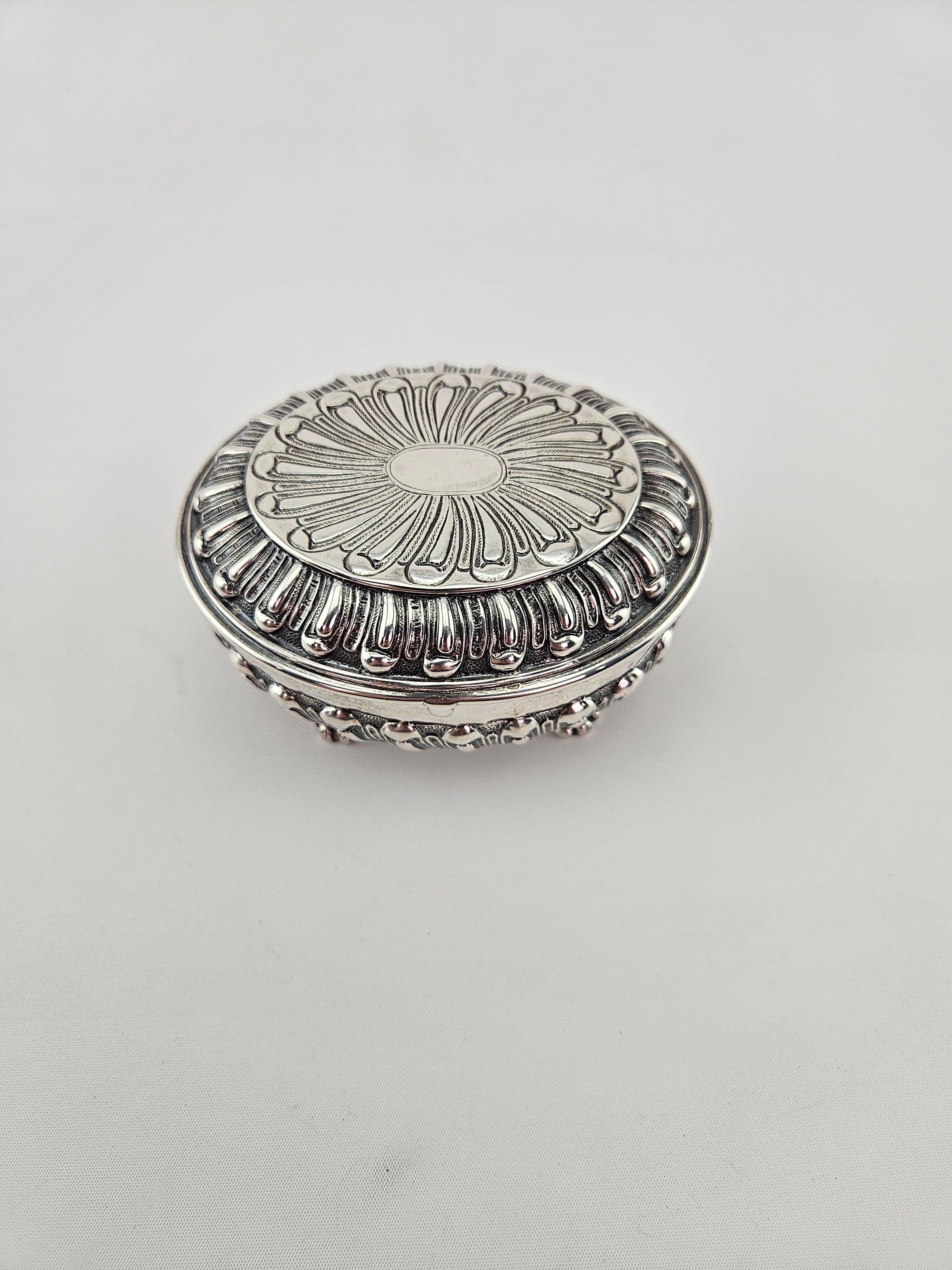 This piece is hallmarked on the underside  with English hallmarks for sterling silver and the maker.   Weight is 200 grams