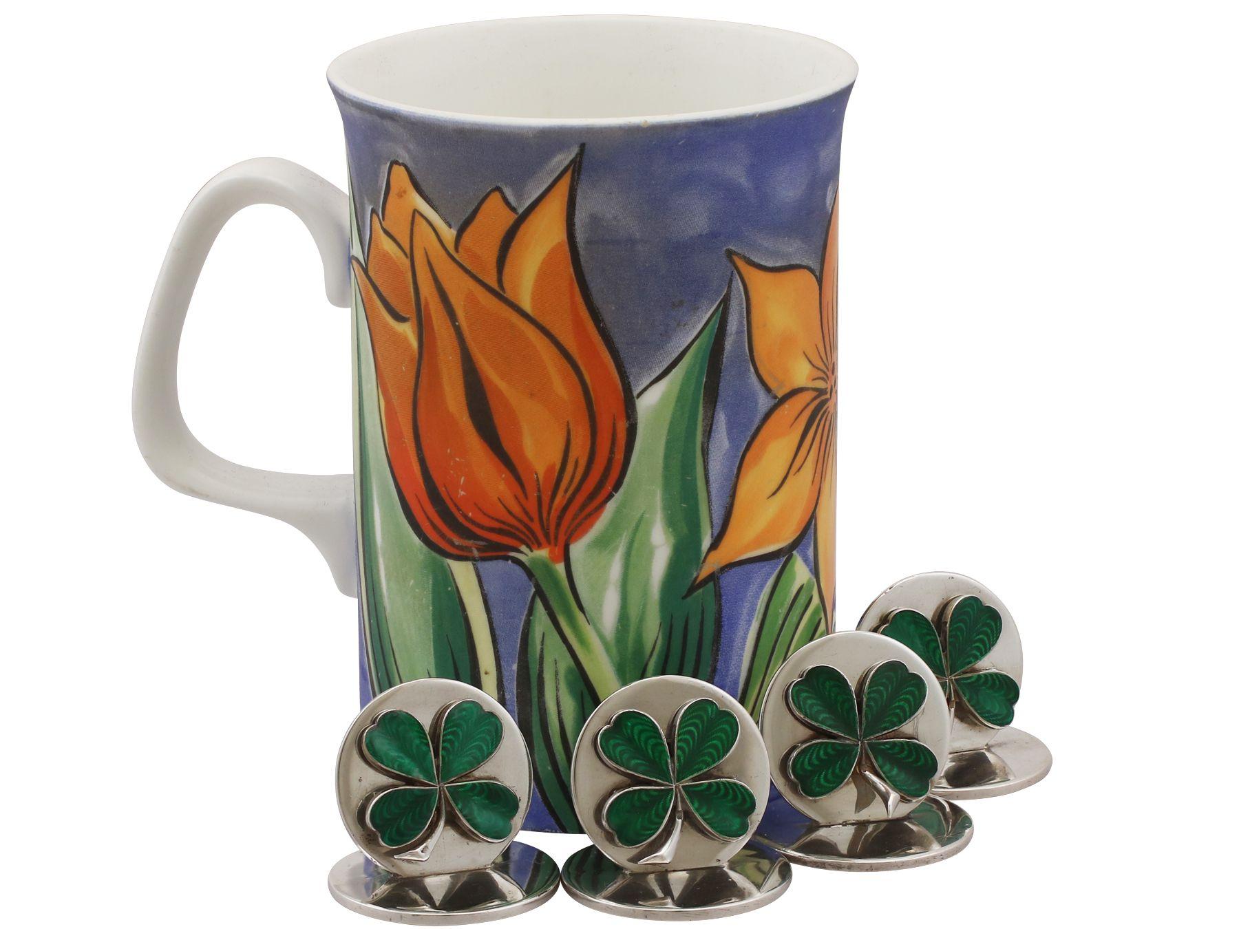 An exceptional, fine and impressive set of four antique George V English sterling silver and enamel four-leaf clover menu / card holders; an addition to our diverse dining silverware collection.

These exceptional antique menu holders, in sterling