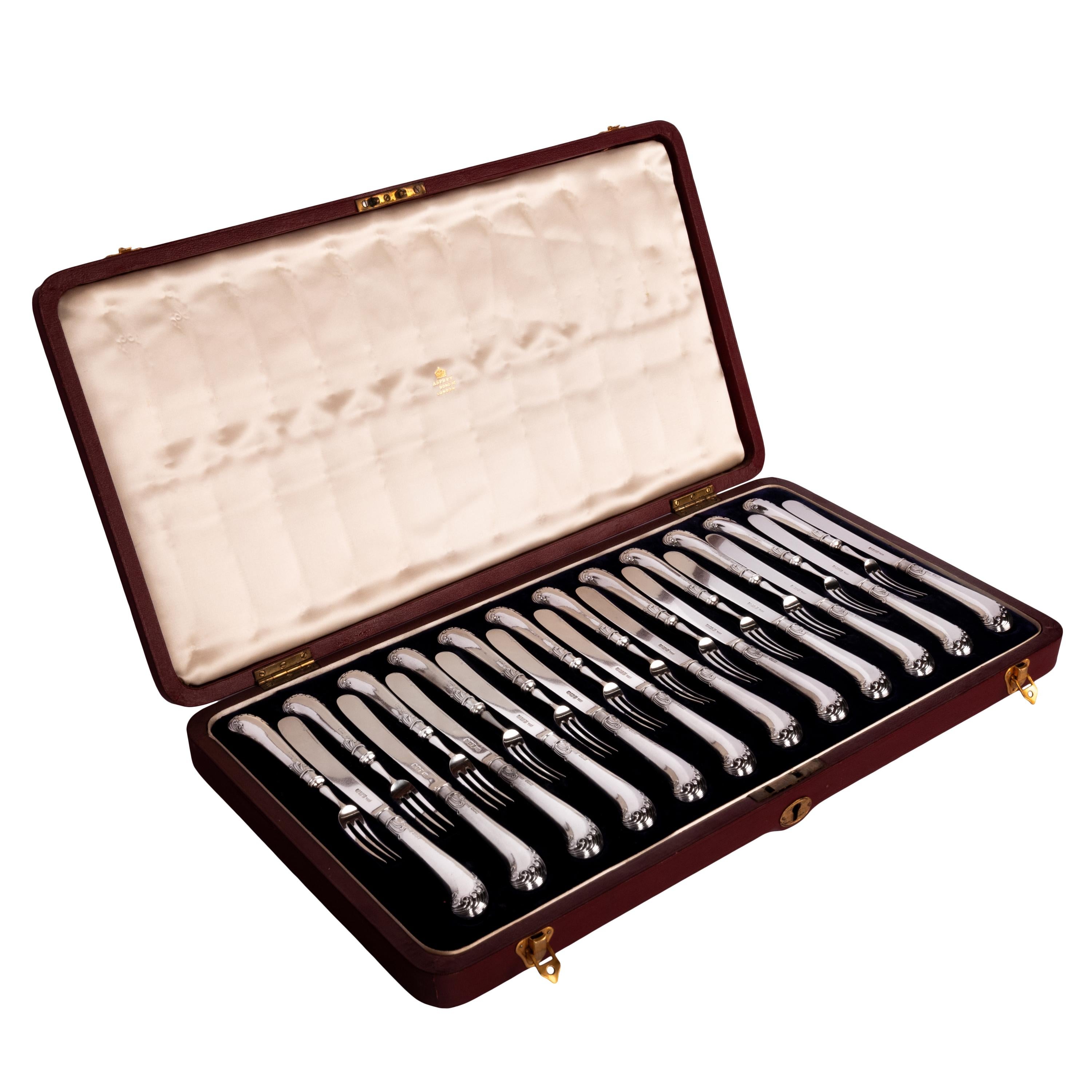 A fine antique cased sterling silver fruit/dessert service for 12 people, made by Allen & Darwin, Sheffield & retailed by Asprey London, dated 1902. Silver weight 34 oz (964 grams)
The set made totally of solid sterling silver; the handles, blades &