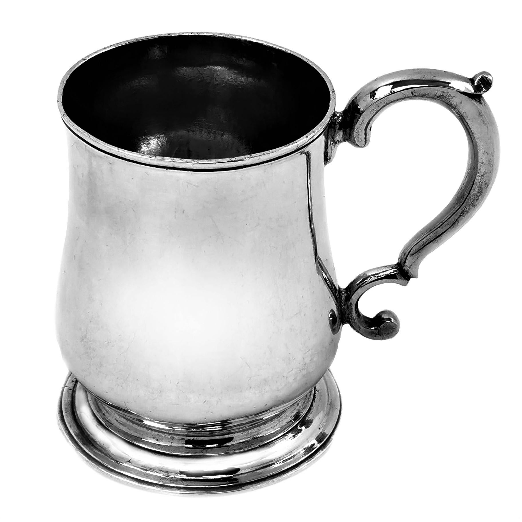 A classic Antique George II solid Silver half pint Mug with a traditional baluster form and with a scroll handle. The Mug has a plain, elegant exterior with a gorgeous patina commensurate with age and use.

Made in London in 1748, Maker