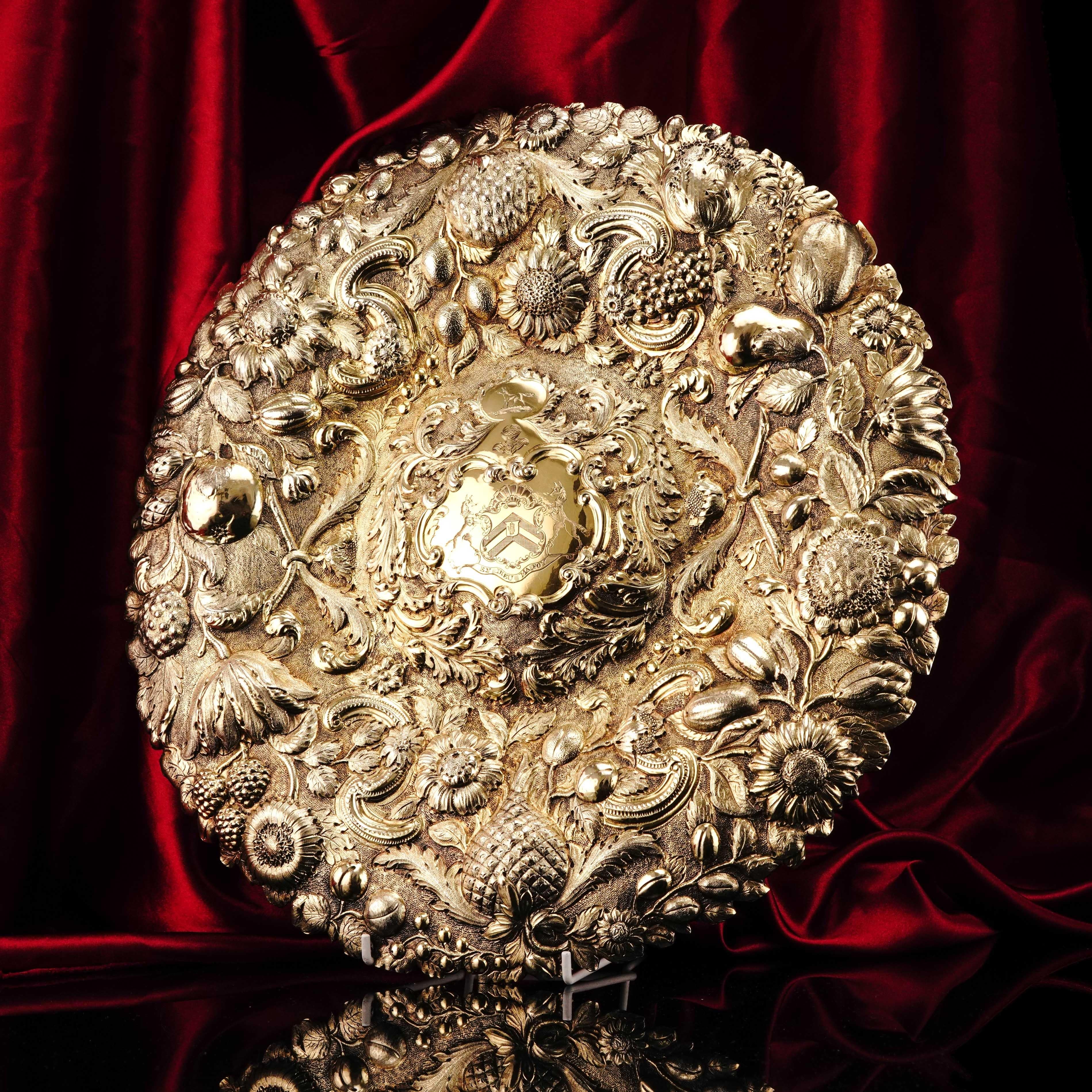 We are delighted to offer this spectacular Georgian solid silver gilt charger/sideboard dish made in London, 1809.
  
Splendour, grand, dazzling, opulent; with certainly no shortage of choice in describing such an impressionable and ornate piece,