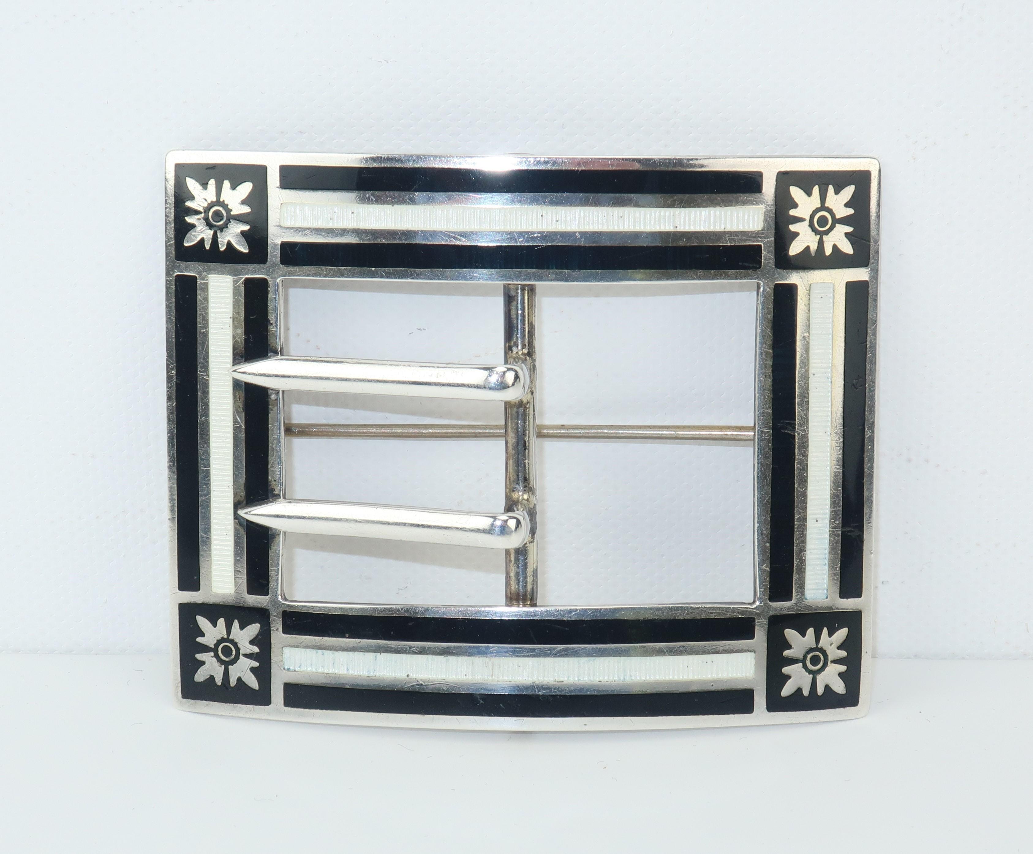 A well placed antique brooch can add stylish character to a jacket or coat and give a modern look a touch of the past.  This early 20th century sterling silver brooch has an unusually modernist style created by a black and white guilloche enamel