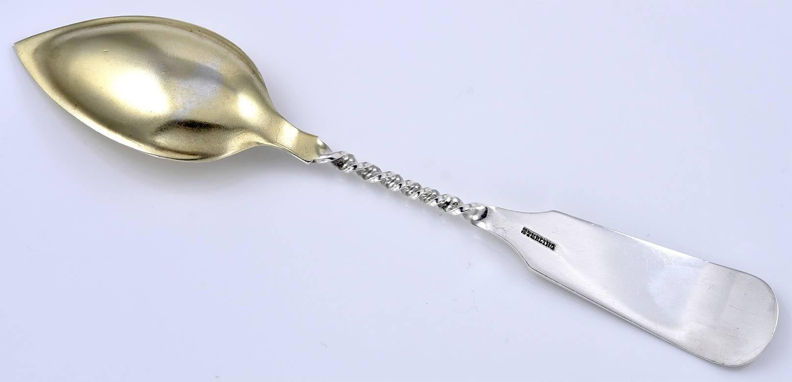 Antique sterling silver dessert spoon.  There is an engraved image of a cathedral, with applied letters that spell out 