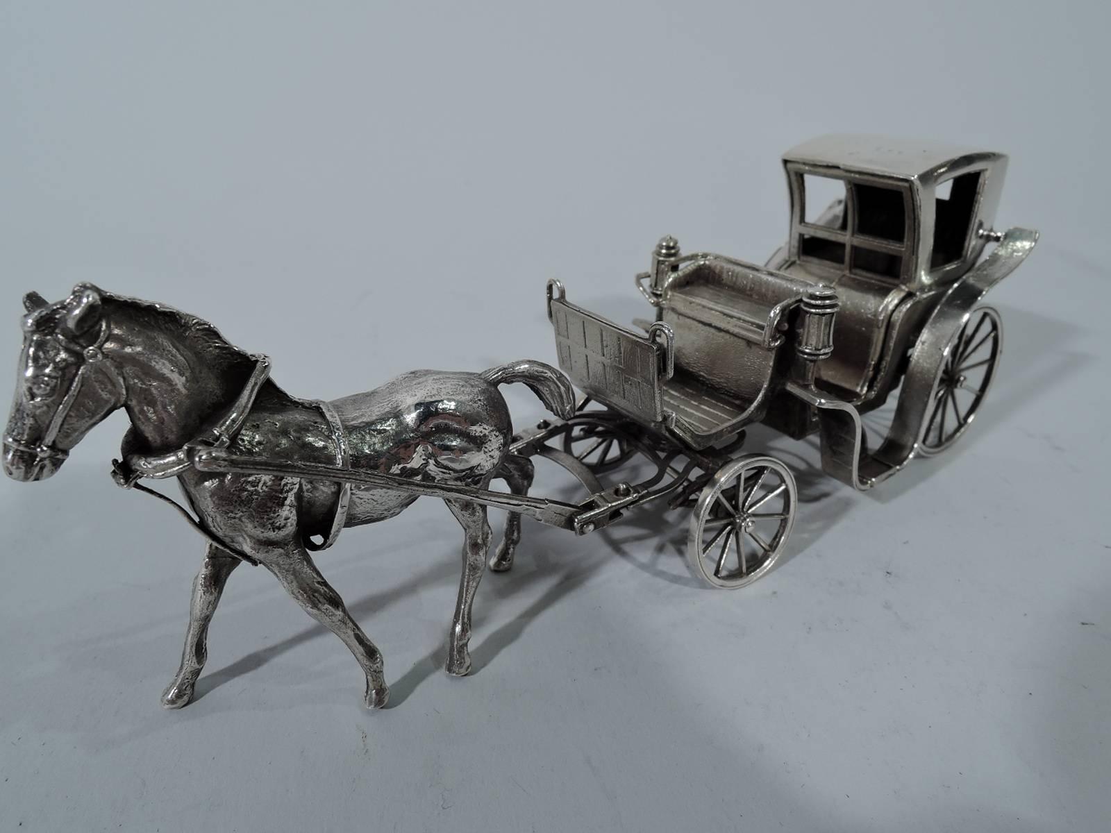 Antique sterling silver horse-drawn brougham. Small and closed with windows. A snug vehicle that awaits a coachman. Harnessed to a ready-to-trot horse. Wheels rotate and front axis turns. Hallmarked “sterling” and “Made in Italy”. Weight: 6.4 troy