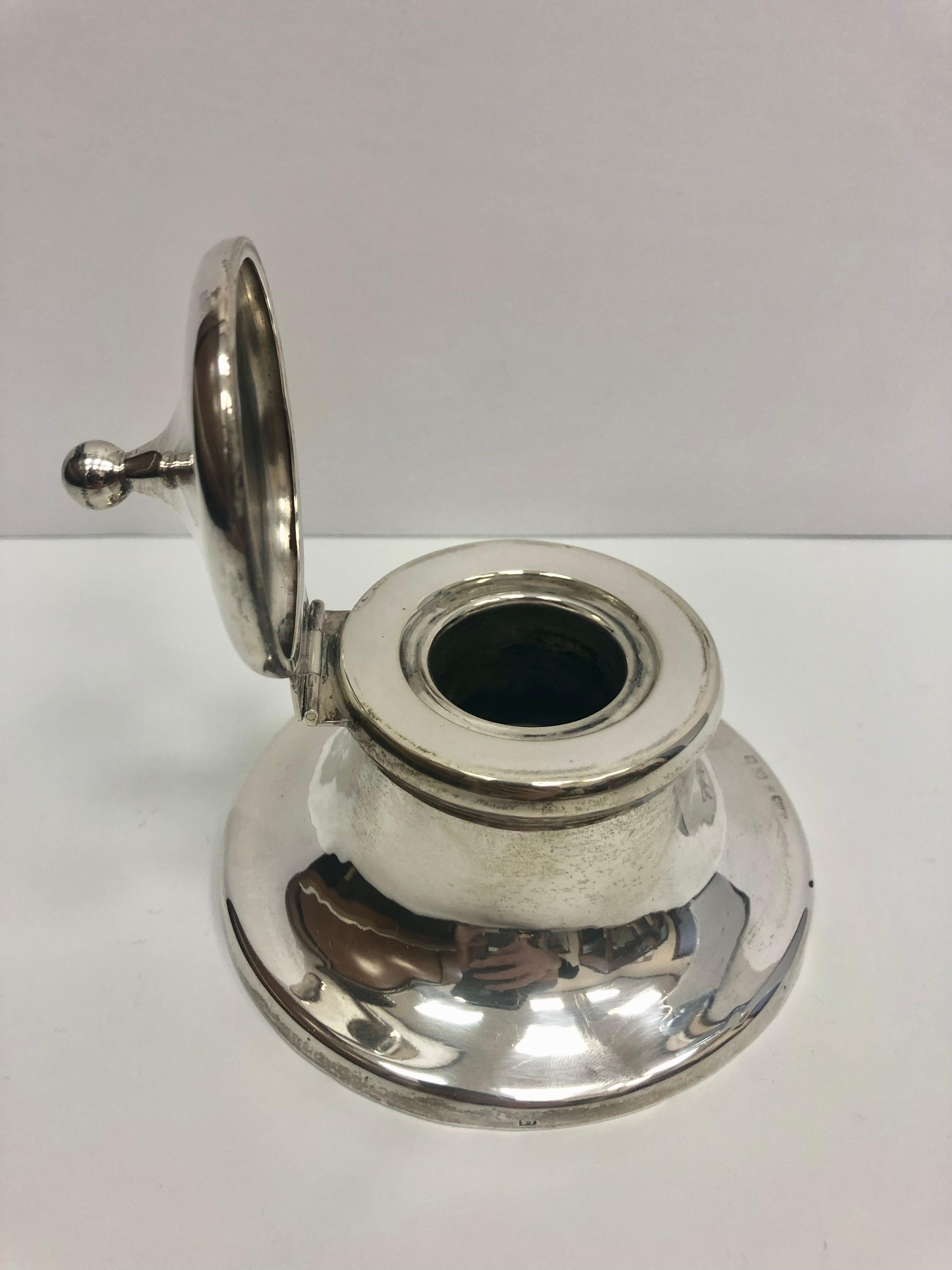 Handsome sterling silver antique inkwell has a lovely, simple design and was made by William Harrison Walter, circa 1905. It has a high polished profile, with a hinged lid and is weighted with a wooden bottom. The piece also has a beautiful hand