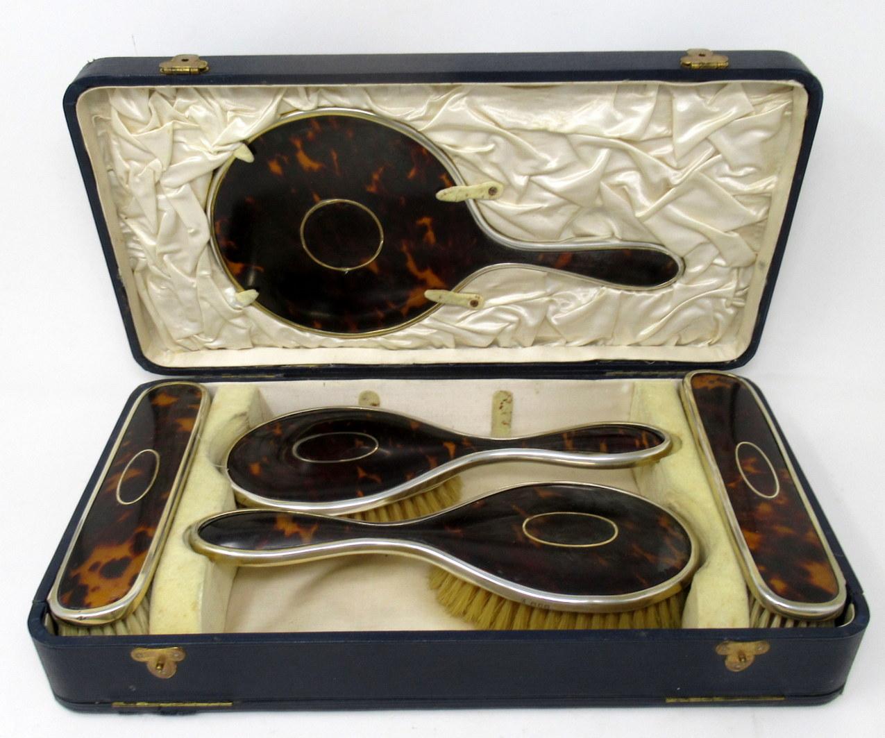 Stunning Edwardian Grand Tour style English sterling silver ladies' cased vanity dressing table grooming set of outstanding quality, with attractive shell inlay detail to all lids.  

Collection included a hand mirror, pair clothes brushes and pair