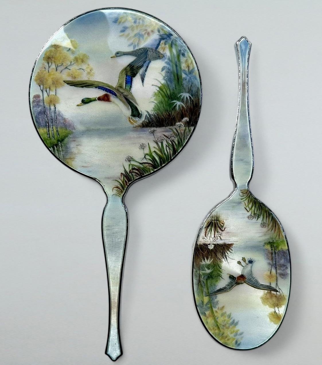 Stylish Mid Century Grand Tour style English sterling silver ladies' vanity dressing table grooming set of outstanding quality, with superb hand painted enamel detail, depicting exotic flying Mallard Birds in landscape over a lake 

Collection