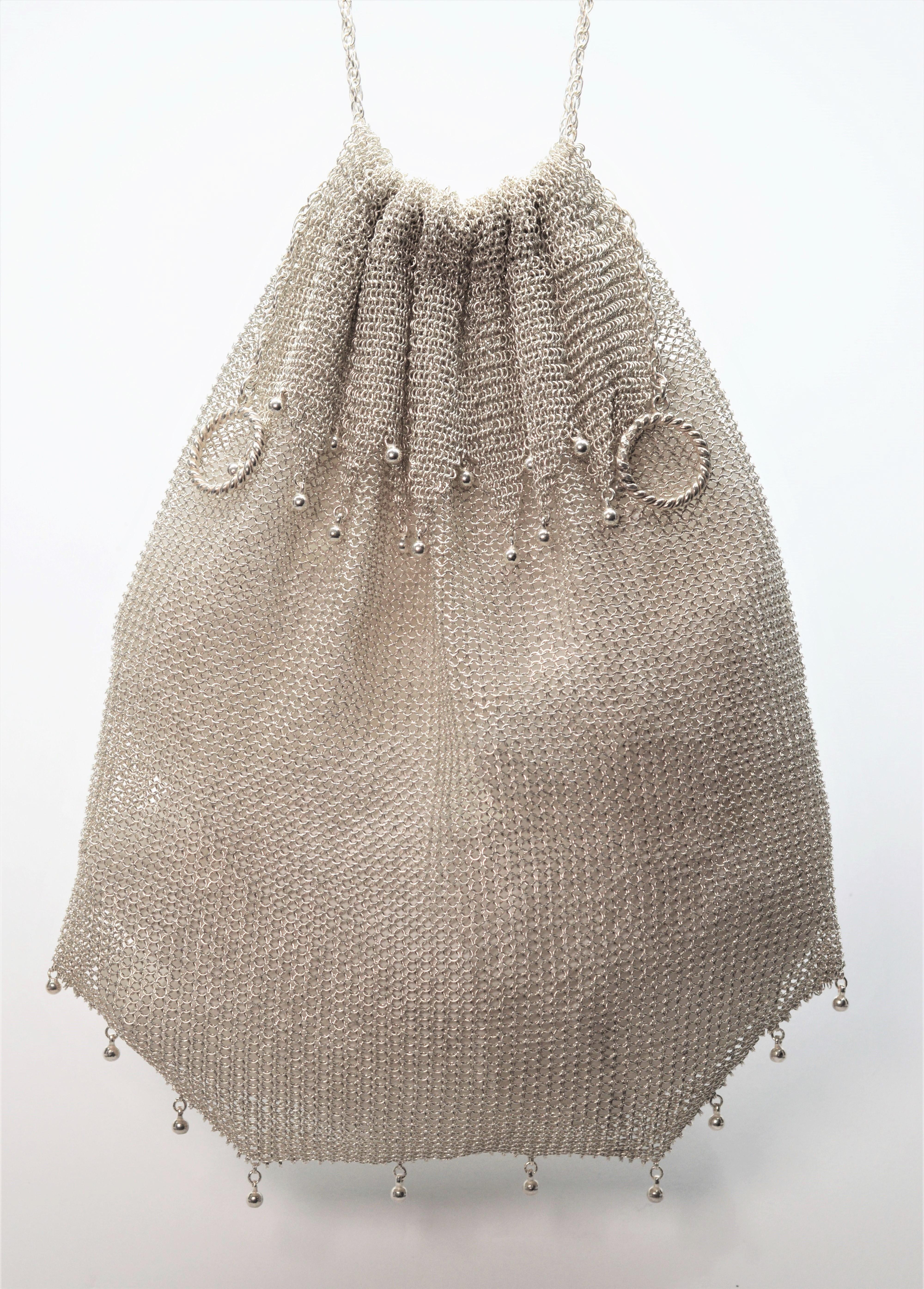 An elegant accessory for bridal or that special evening occasion. Circa pre-war, this finely made continental European lady's evening bag is entirely made of sterling silver. The neck of this drawstring purse is enhanced with a decorative collar