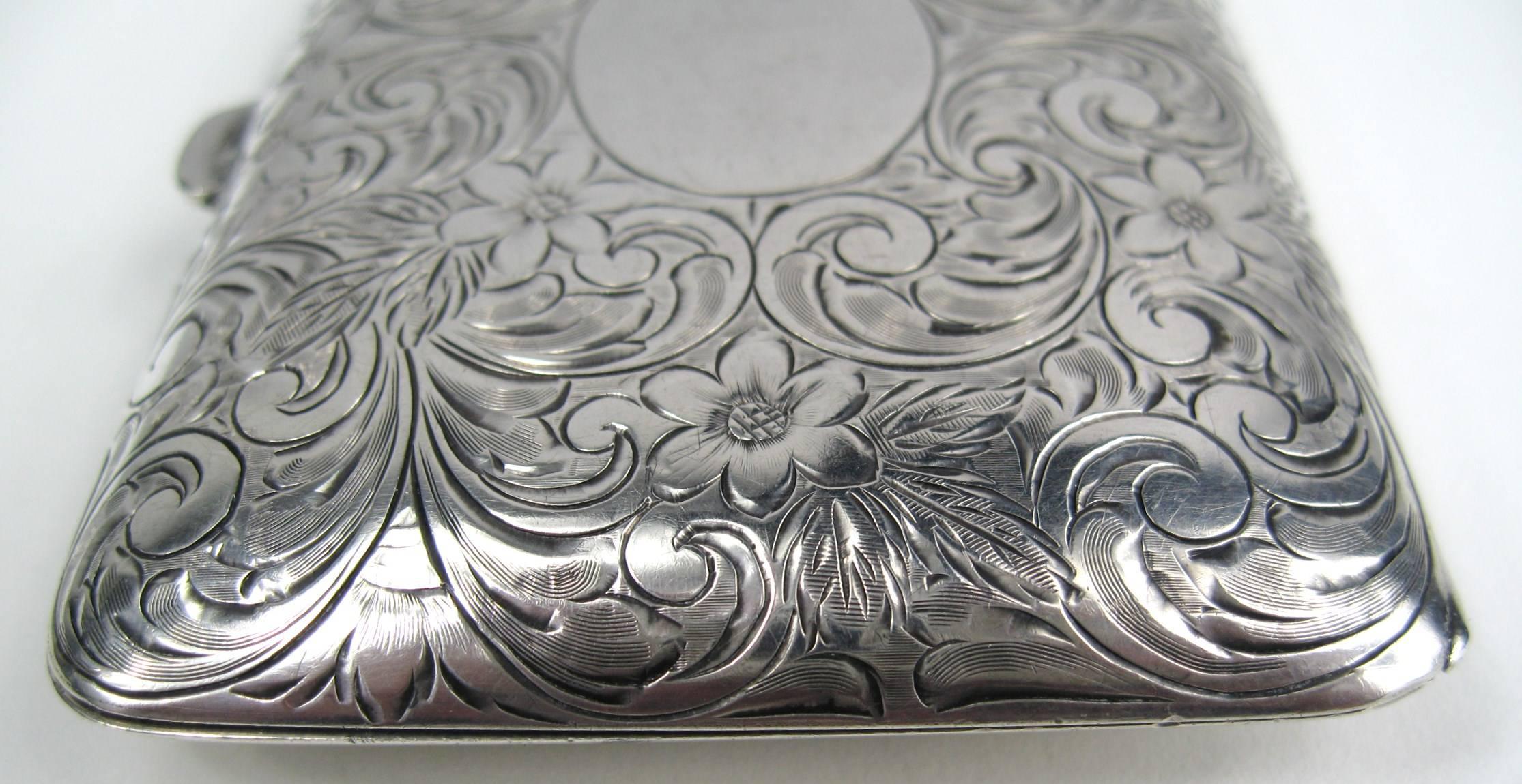 Stunning Sterling Silver Compact Purse. Lovely floral Motif detailing. Center space for Monogramming. Purse has a very small chain at the top. Coin holders and mirror all in wonderful condition. there is a slot for a couple of nickels and dimes), a