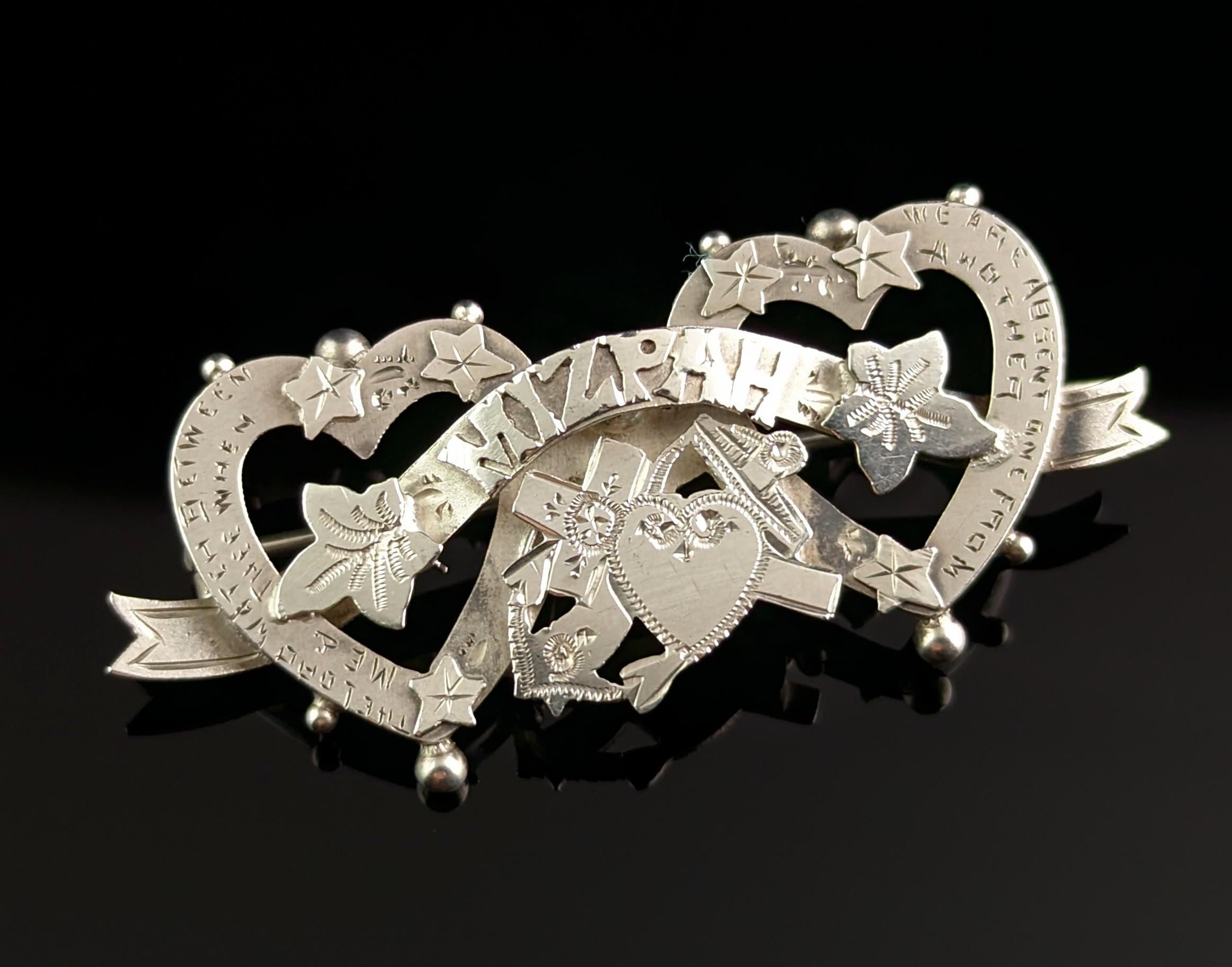 A beautiful antique, late Edwardian era sterling silver Mizpah brooch.

This brooch is so chocked full of sentiment with something new speaking out every time you look at it.

It is a double entwined heart brooch with the sentimental Mizpah to the