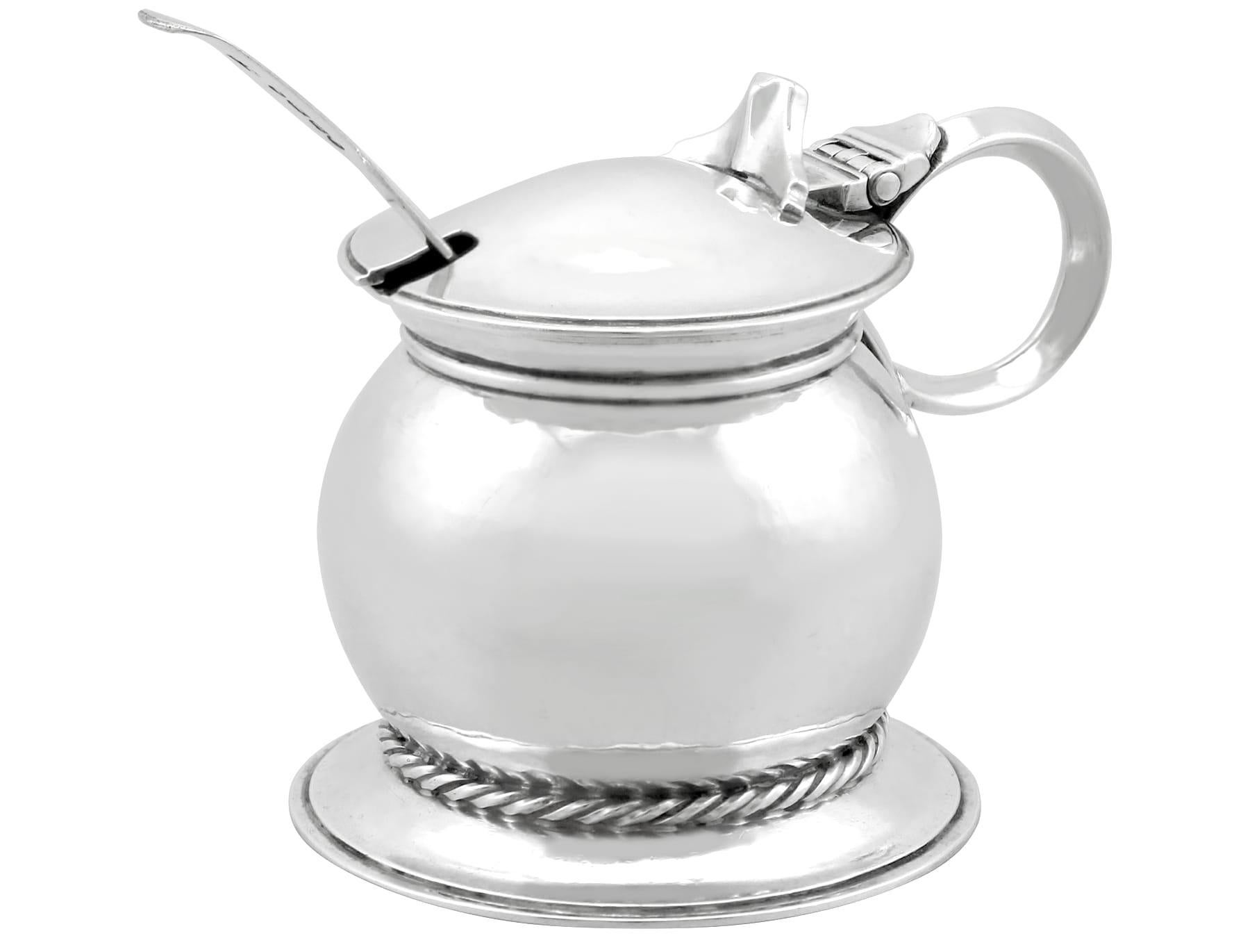An exceptional, fine and impressive, unusual antique George V English sterling silver mustard pot made by Omar Ramsden in the Arts and Crafts style; an addition to our collectable silverware collection.

This exceptional antique George V sterling