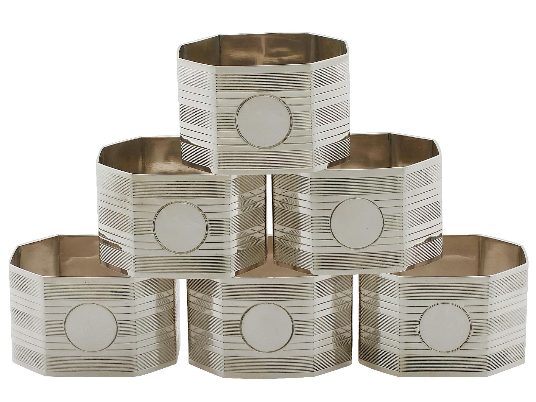 An exceptional, fine and impressive set of six antique George V English sterling silver napkin rings - boxed; an addition to our dining silverware collection.

This exceptional set of antique George V silver napkin rings consists of six napkin