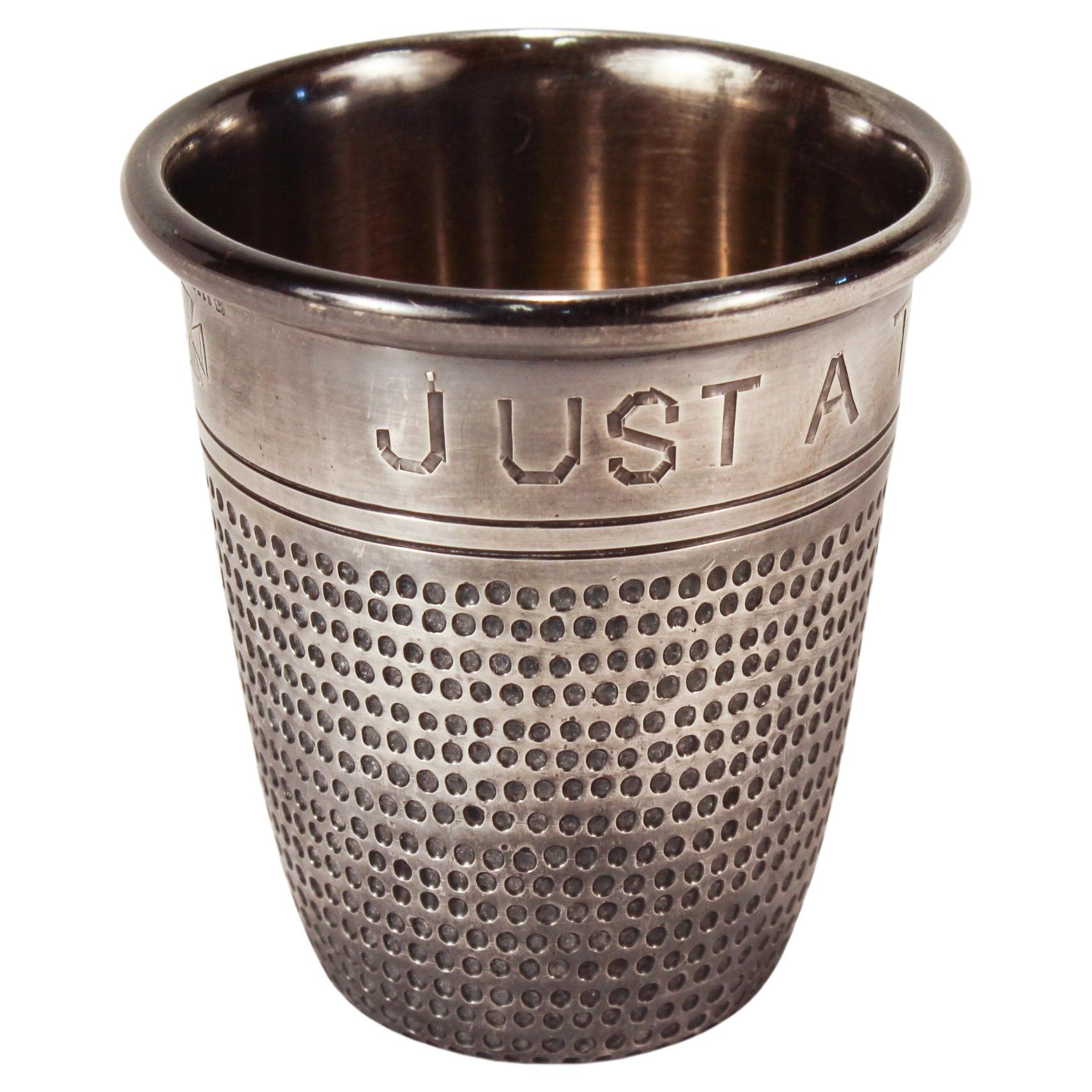 A fine antique sterling silver liquor measure or jigger.

In the form of an over-sized silver thimble. 

Engraved around the rim 