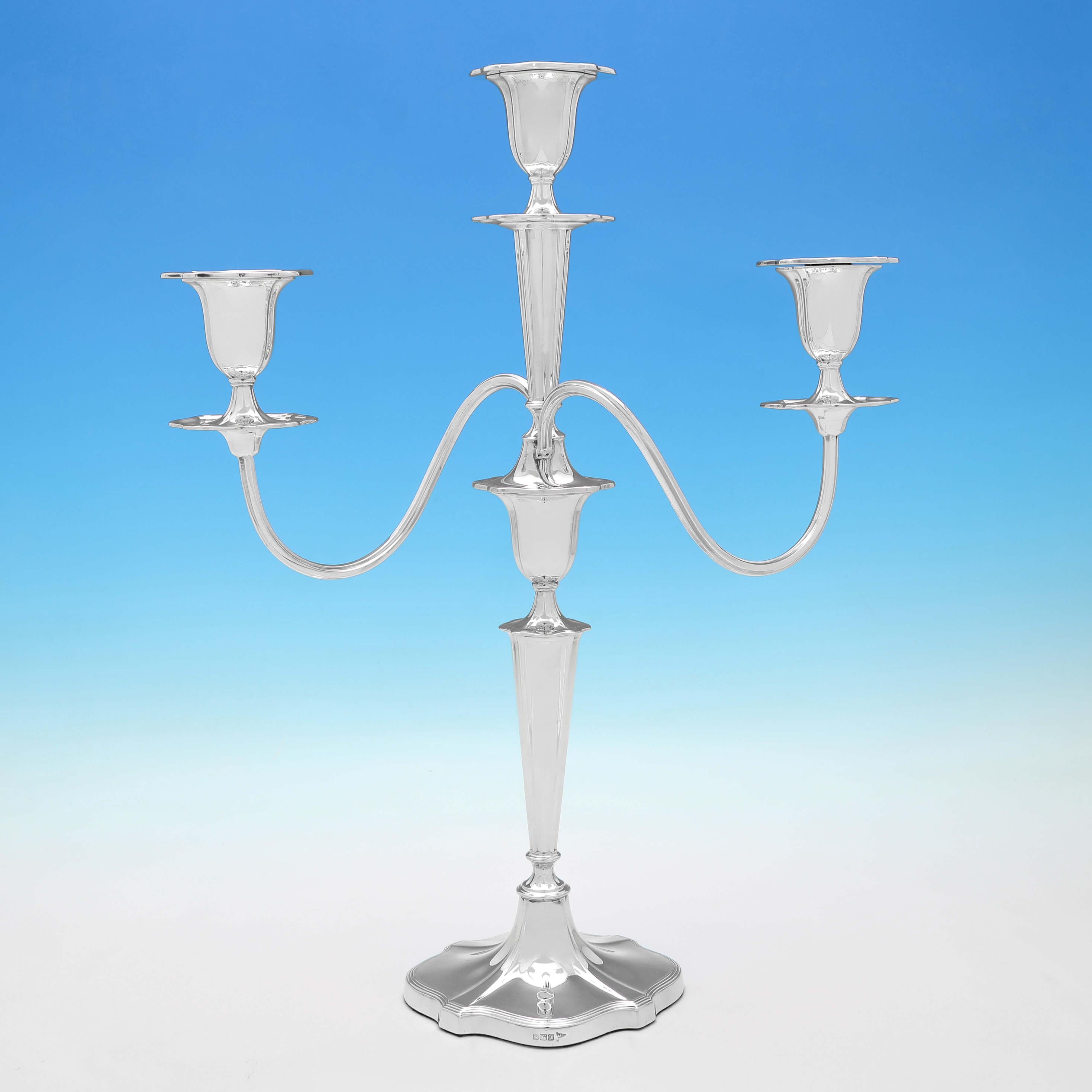Hallmarked in Sheffield in 1914 by Walker & Hall, this handsome pair of Antique Sterling Silver Candelabra, are oval in shape, with reed borders, and will each hold 3 candles. 

Each candelabrum measures 20