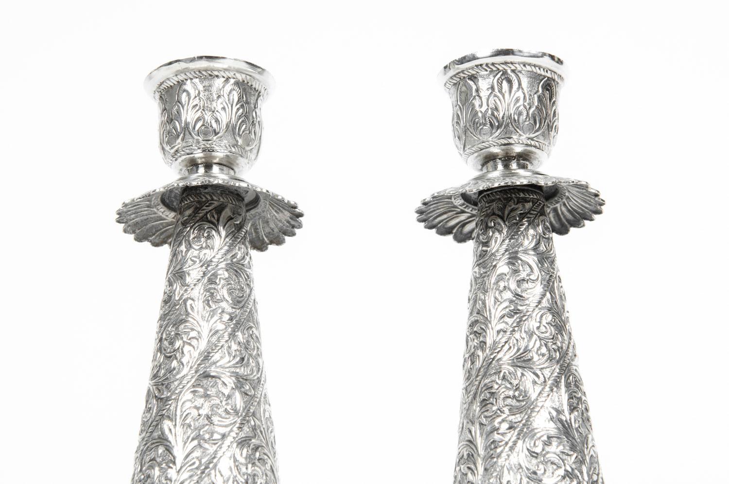 Antique sterling silver pair candlestick with exterior design details. Each candle stick is in excellent antique condition. Each one measure about 9.7 inches high x 3 inches base diameter.