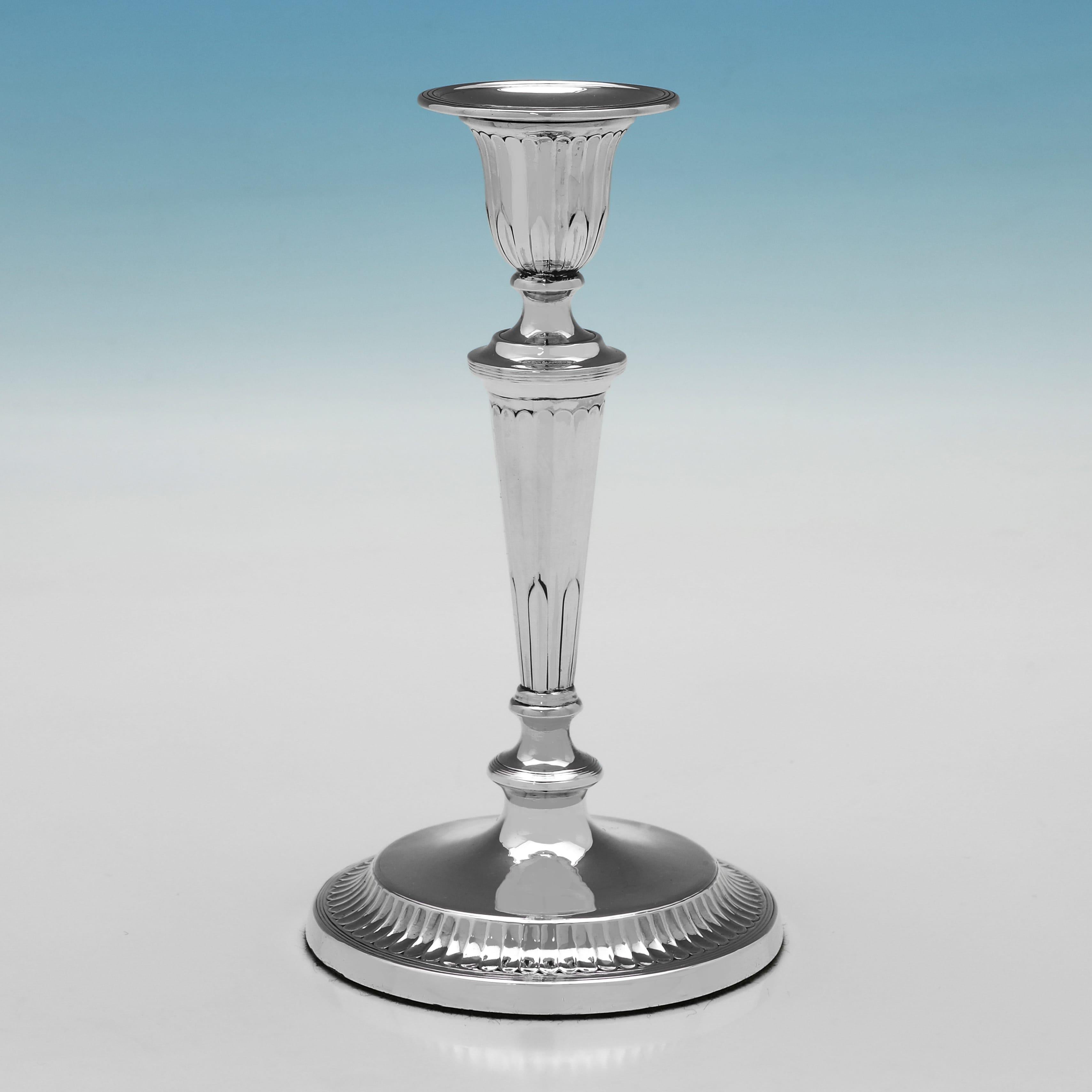 Hallmarked in Sheffield in 1917 by Thomas Bradbury, this attractive, Antique, George V period, Sterling Silver Pair of Candlesticks, are round in shape, and feature sunken fluting and removable nozzles. 

Each candlestick measures 7.25