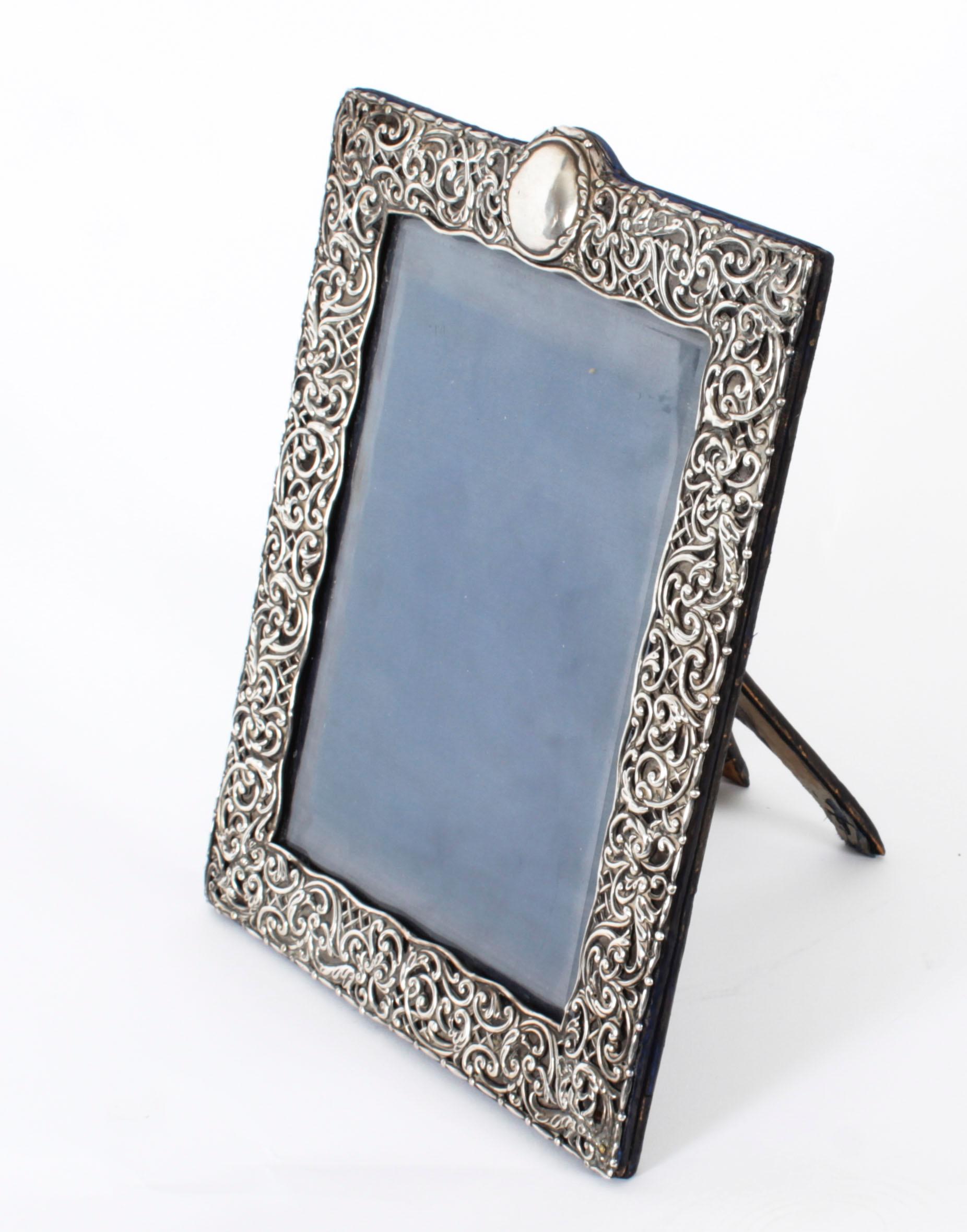 A truly superb antique Edwardian decorative sterling silver photograph frame the die stamped mount with C-scrolls and trellis, by Henry Matthews, Birmingham 1902.
 
Beautifully portrait frame decorated with relief floral, foliate and scroll