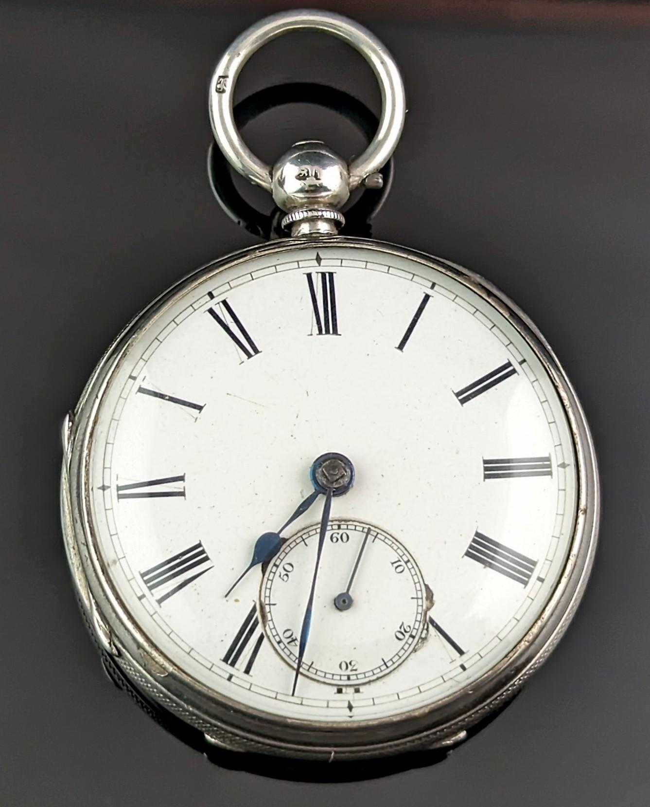 A handsome antique mid Victorian silver pocket watch.

It has a white enamel dial with black roman numerals and blued steel hands, there is a subsidiary second dial to the bottom of the dial.

To the reverse there is an order of the garter belt with