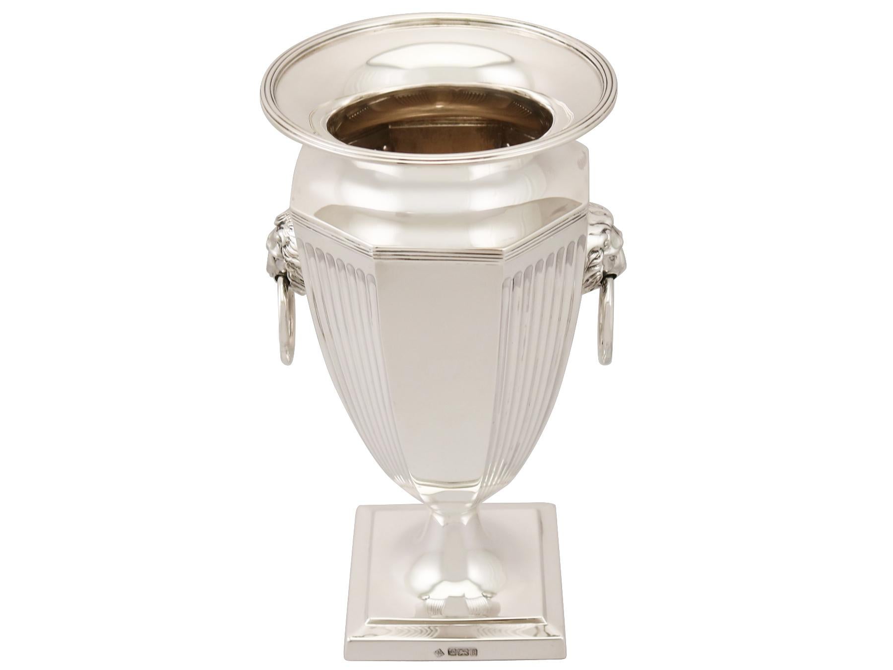 An exceptional, fine and impressive antique George V English sterling silver presentation vase; an addition to our ornamental silverware collection.

This exceptional antique sterling silver vase has a plain octagonal panelled rounded form onto a