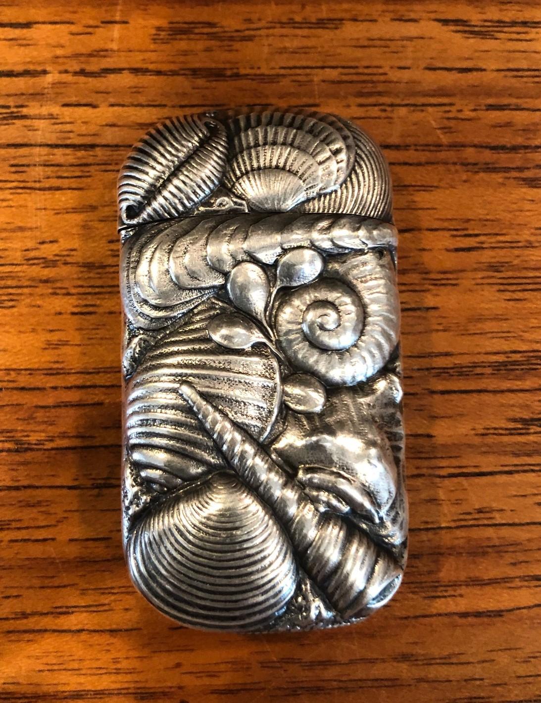 A very rare antique sterling silver repoussé match safe / vesta with shell decoration by George Shiebler & Co., New York, New York, circa 1890s. The piece is in superb condition with a hinged lid and a match strike bottom. Marked with Shiebler's