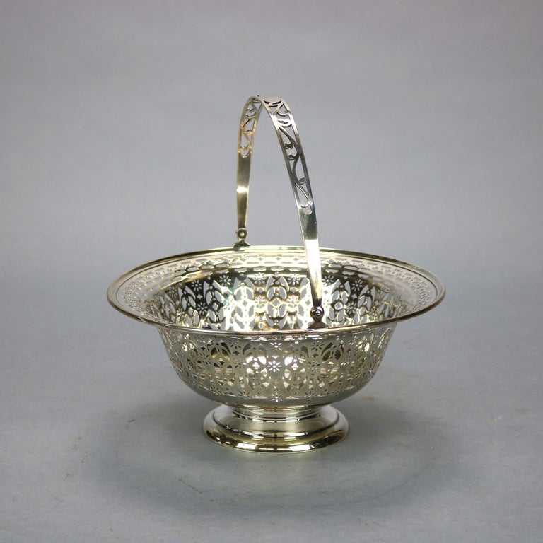 An antique sterling silver basket offers reticulated bowl with swivel handle, marked on base as photographed, 15.81 toz, c1890

Measures: 5.25