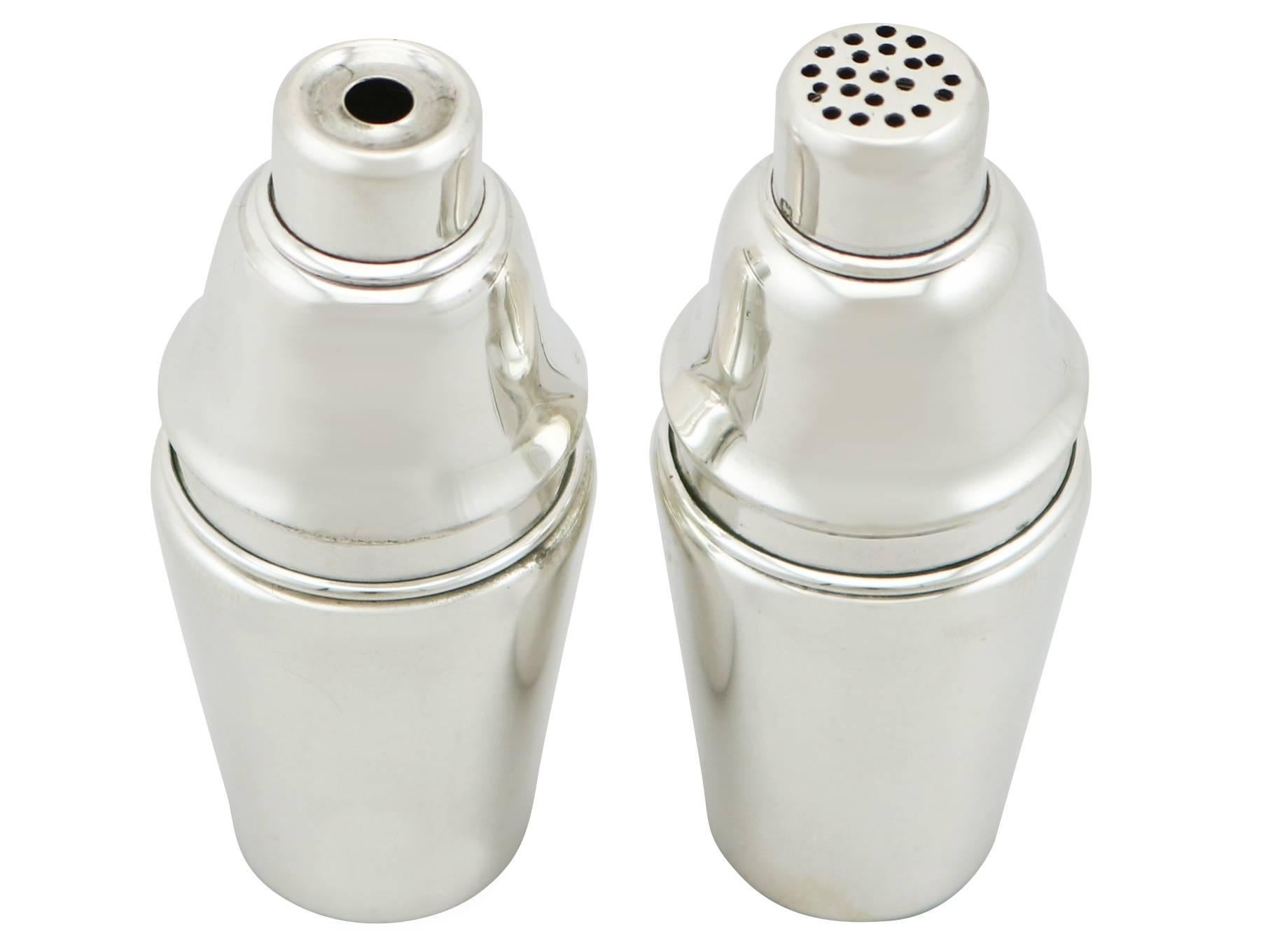 An exceptional, fine and impressive pair of antique George V English sterling silver salt and pepper shakers; an addition to our silver cruets/condiments collection.

These fine antique George V sterling silver salt and pepper shakers are