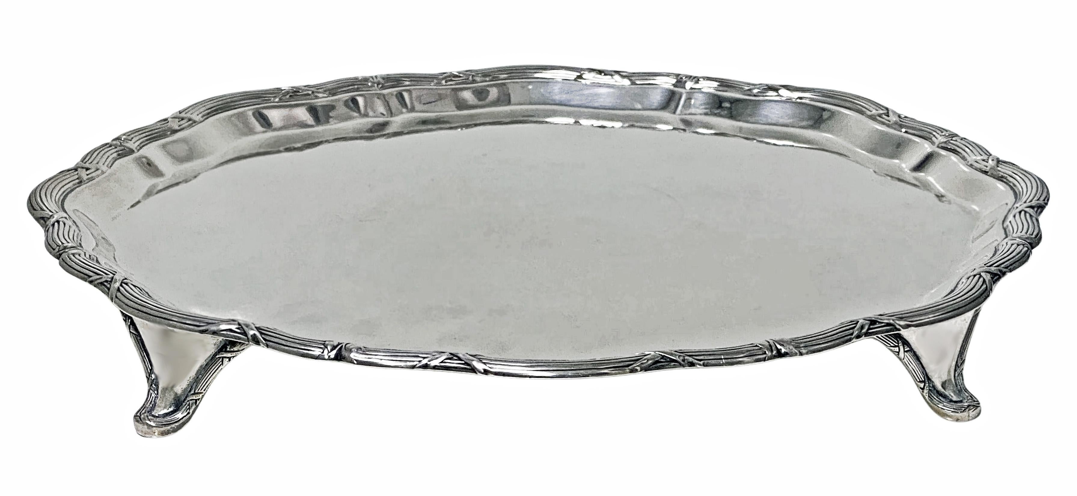 Antique Sterling Silver Salver Tray 1906 by J & J Maxfield Ltd. The Georgian style Salver of circular shape, reed and ribbon border on four turned supports plain centre. Diameter: Approximately 12 inches. Weight: Approximately 26.5 oz.