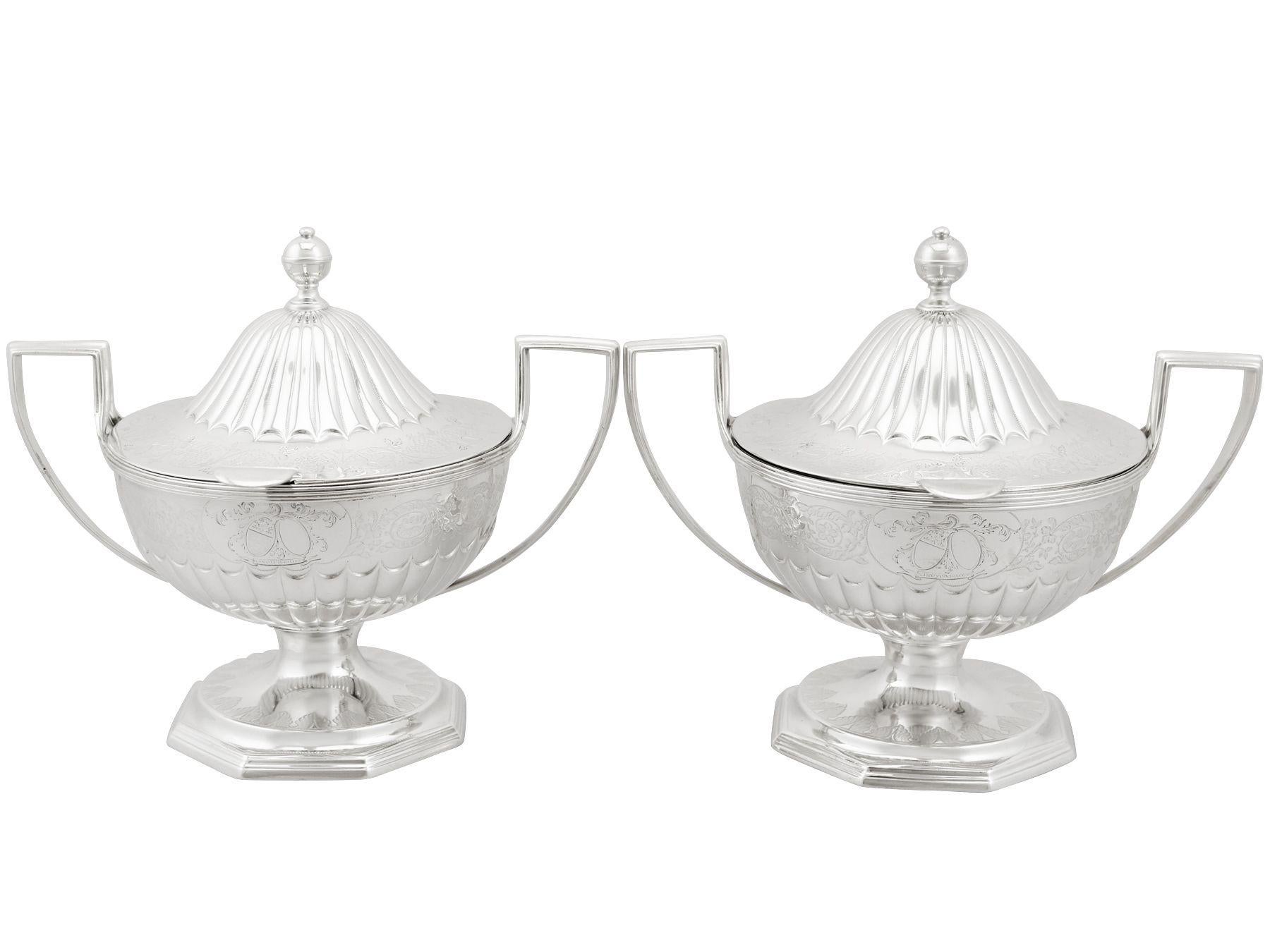 An exceptional, fine and impressive pair of antique Georgian English sterling silver sauce tureens; an addition to our Georgian silverware collection.

These exceptional antique George III sterling silver sauce tureens have a circular rounded form