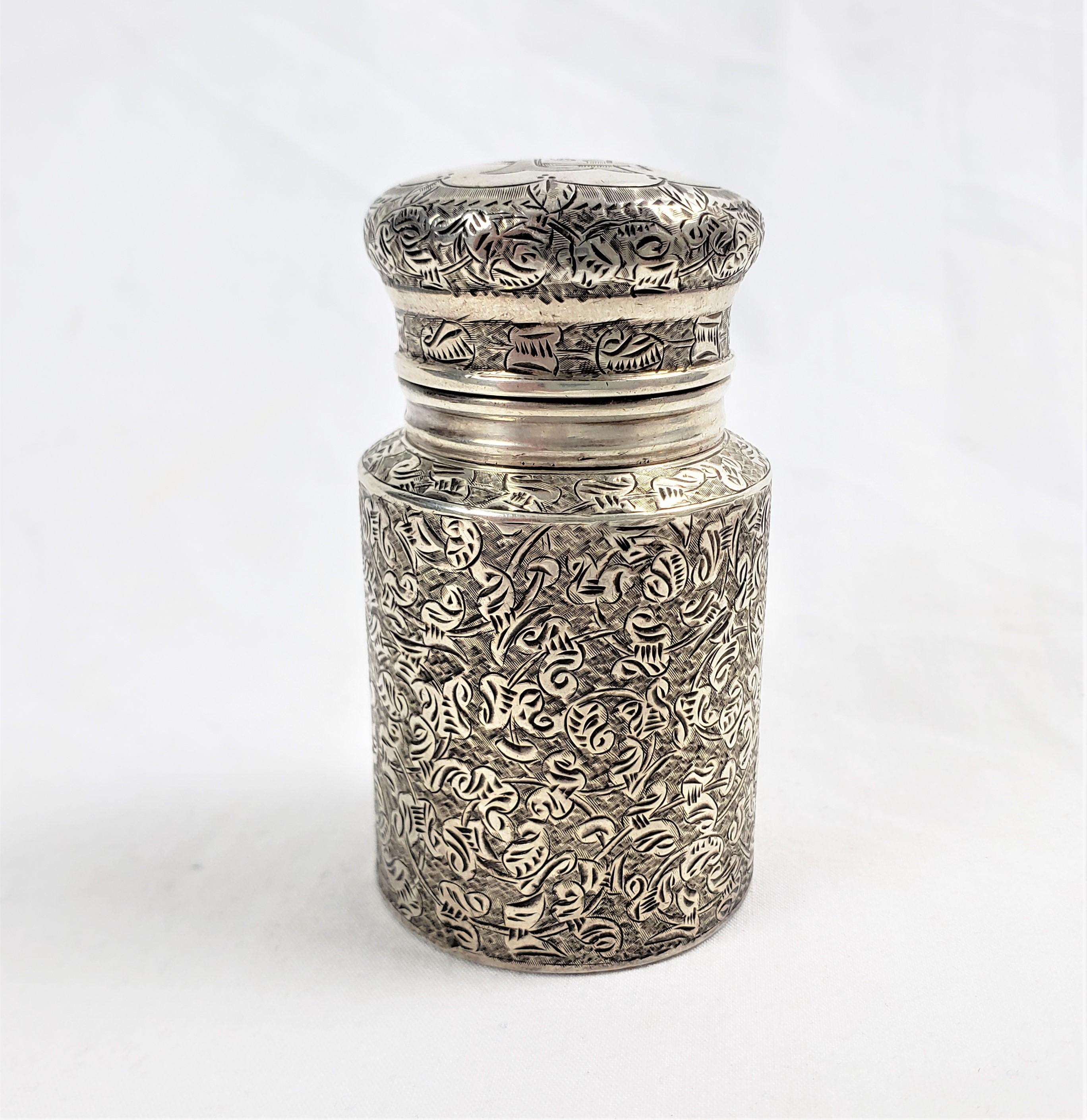 This antique perfume bottle is signed by an unknown English maker and dates to approximately 1898 and done in the period Victorian style. The bottle is done in sterling silver with a milk can shape with chased decoration on both the top and sides.
